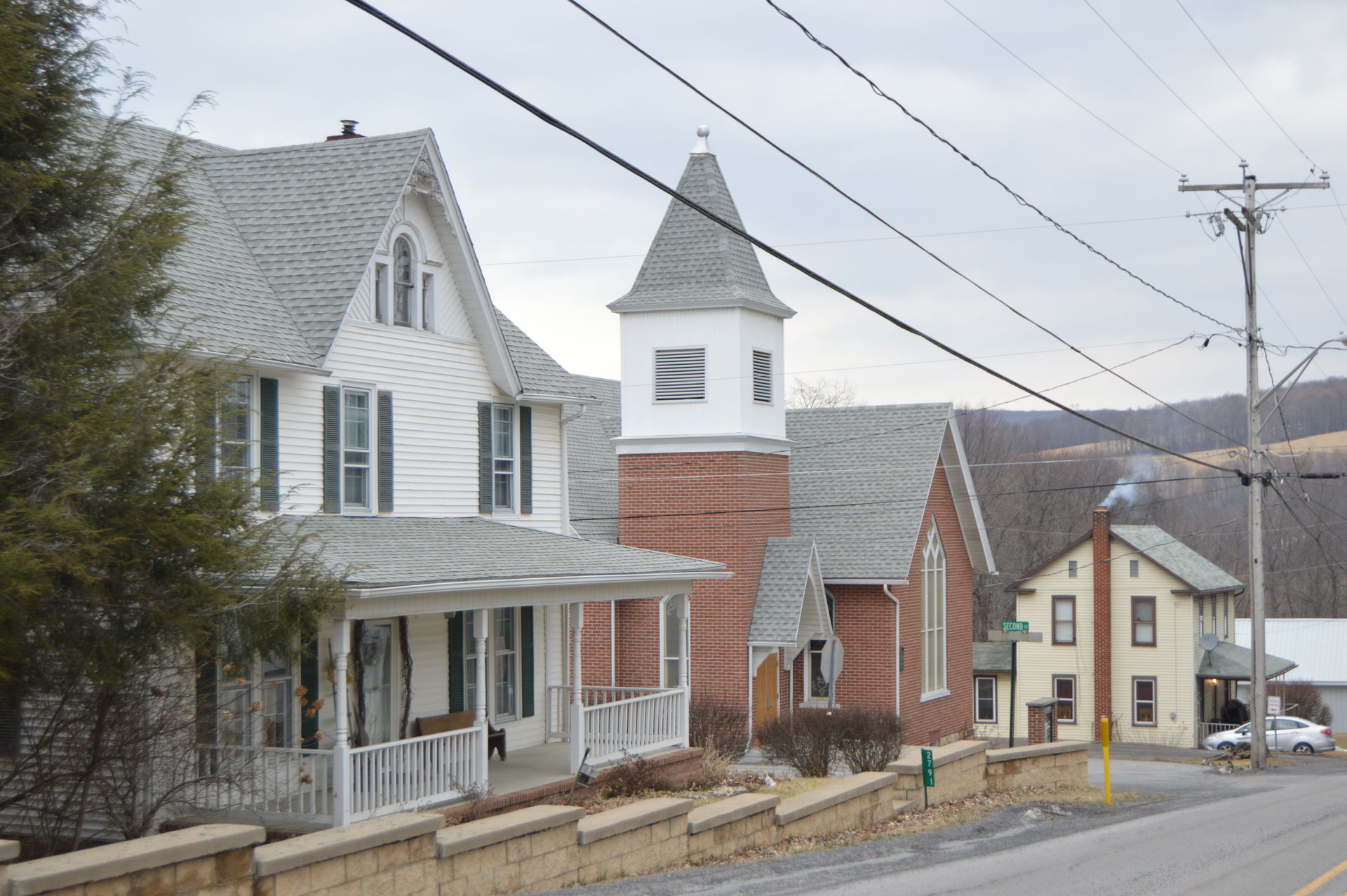 Houses and the Methodist church located on the northern side of…