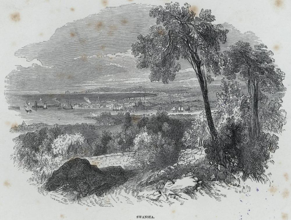 A view overlooking Swansea town and the bay with a few boats in…