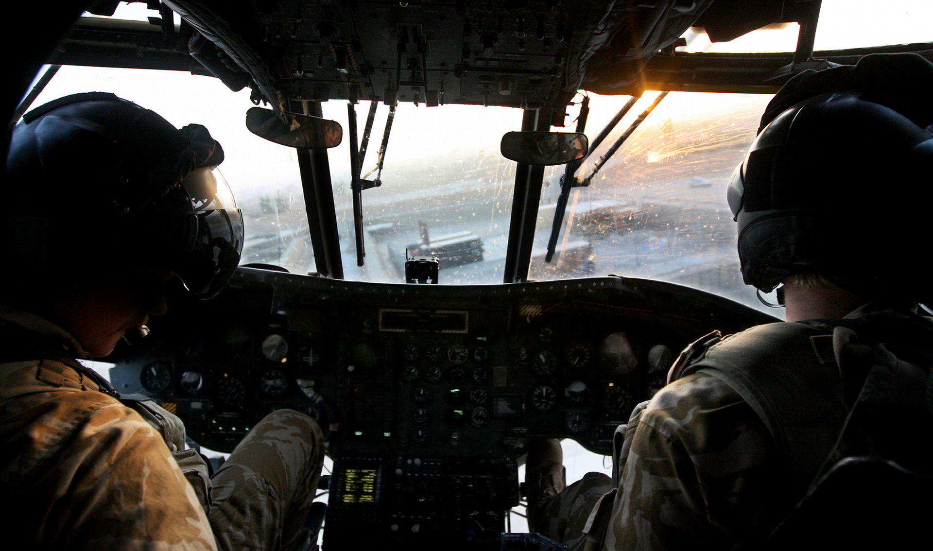 The aircrew of a Royal Air Force Chinook helicopter guide their…