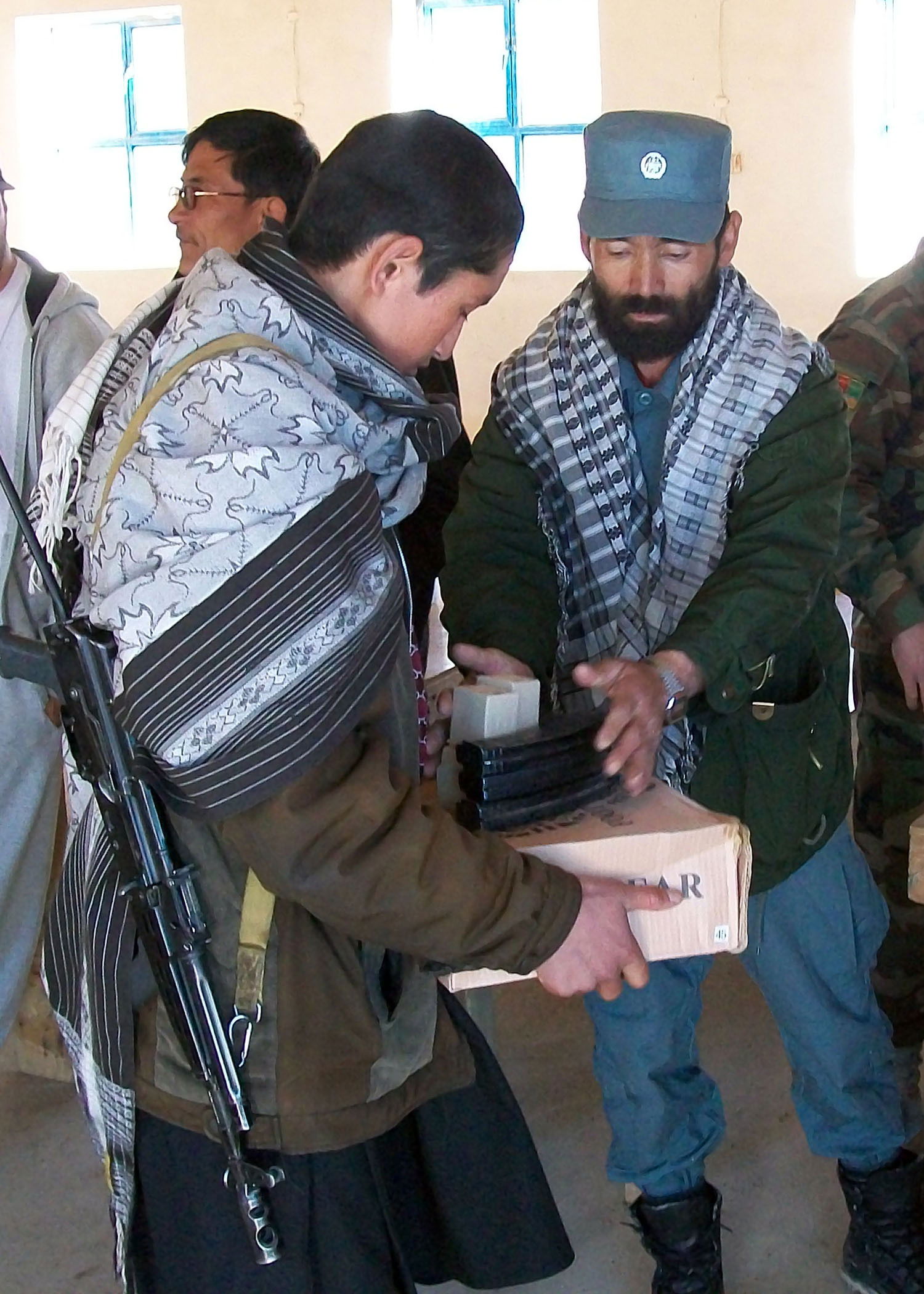 The Khas Uruzgan assistant district chief of police distributes…