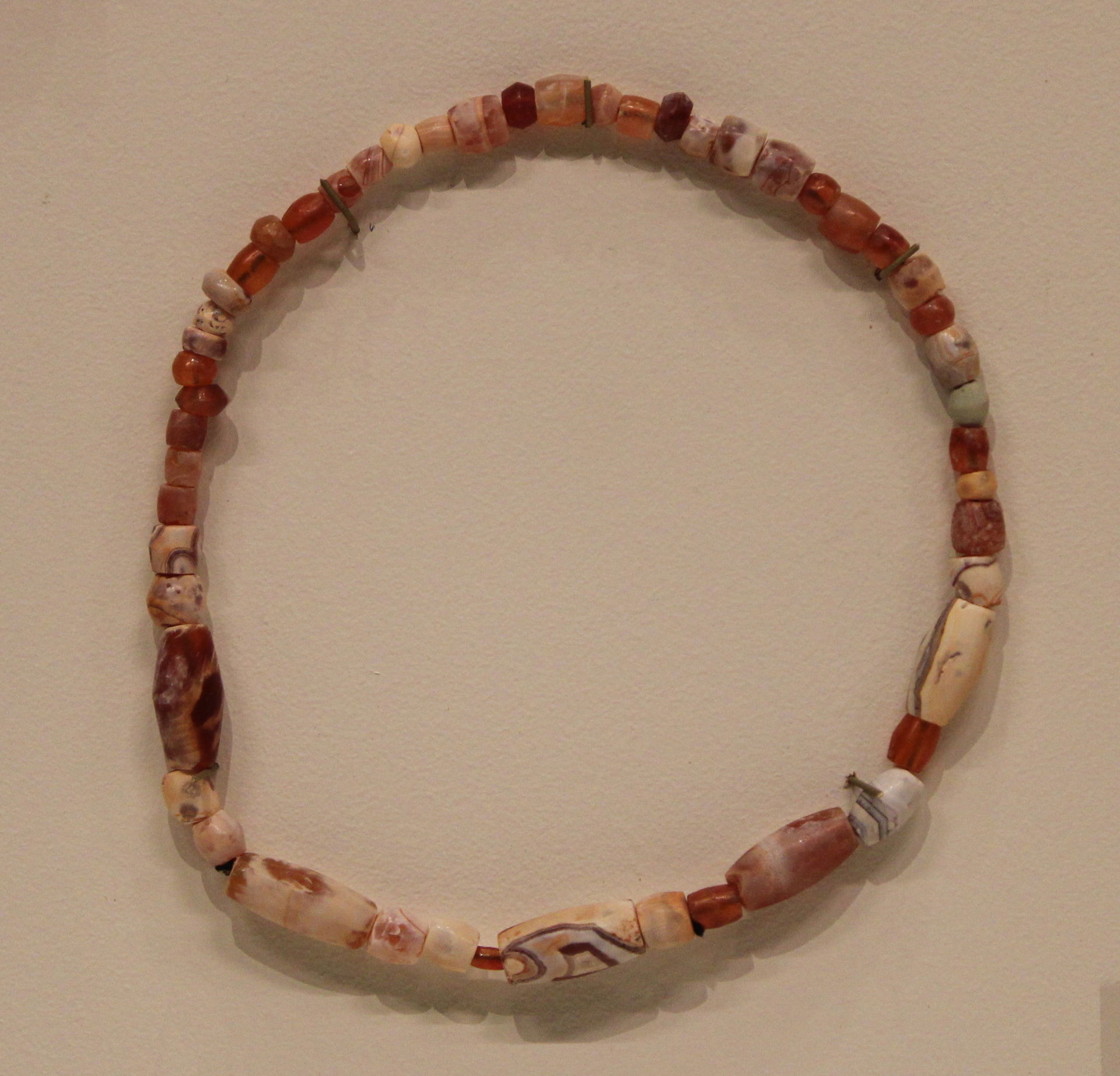 Carnelian bead necklace unearthed at Madinat Hamad (Bahrain). A…