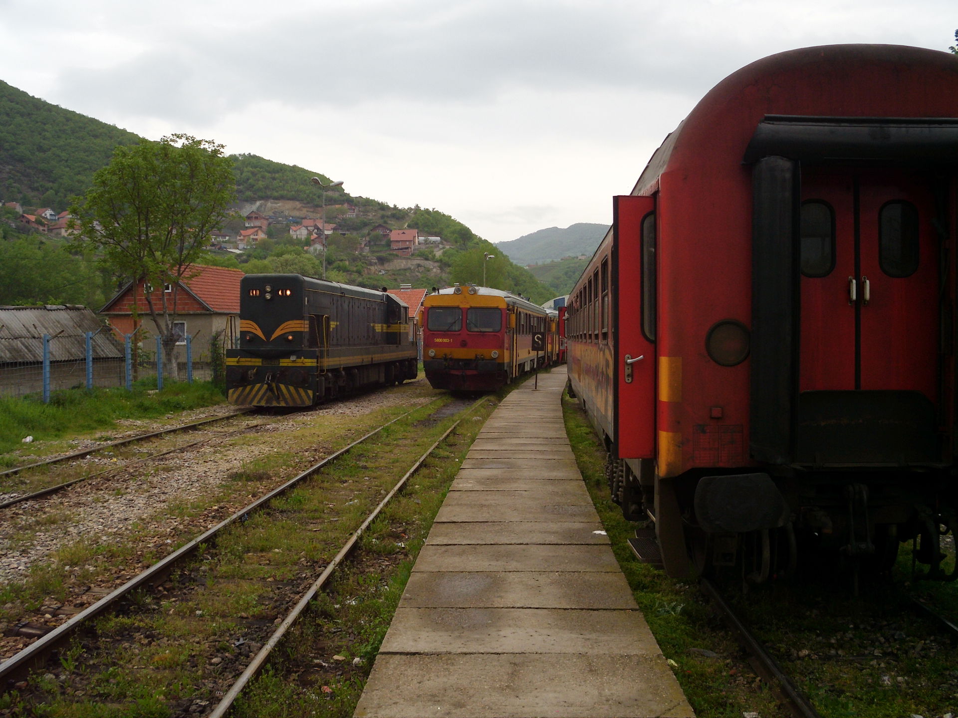 Two passenger trains and one diesel engine in the border statio…