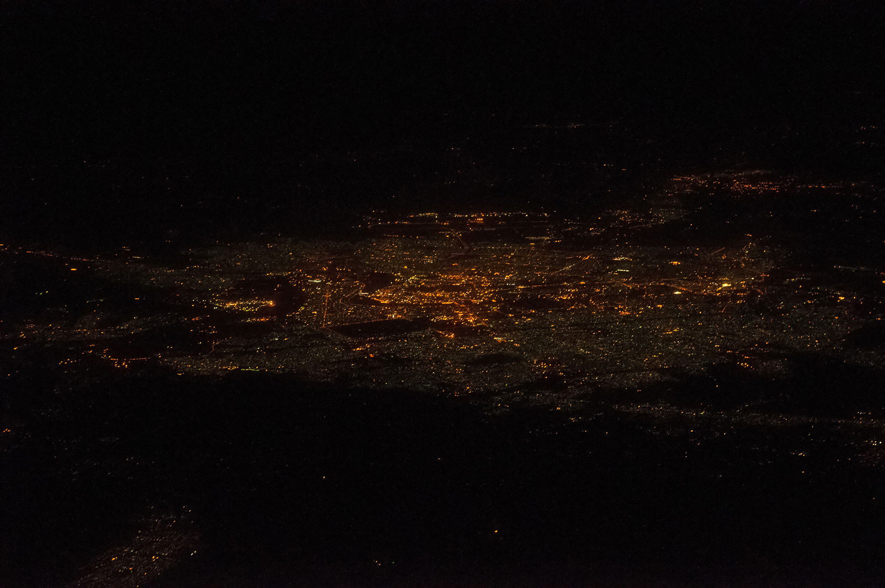 Bagdad in Iraq at night. View from East; height, 35,000 feet; d…
