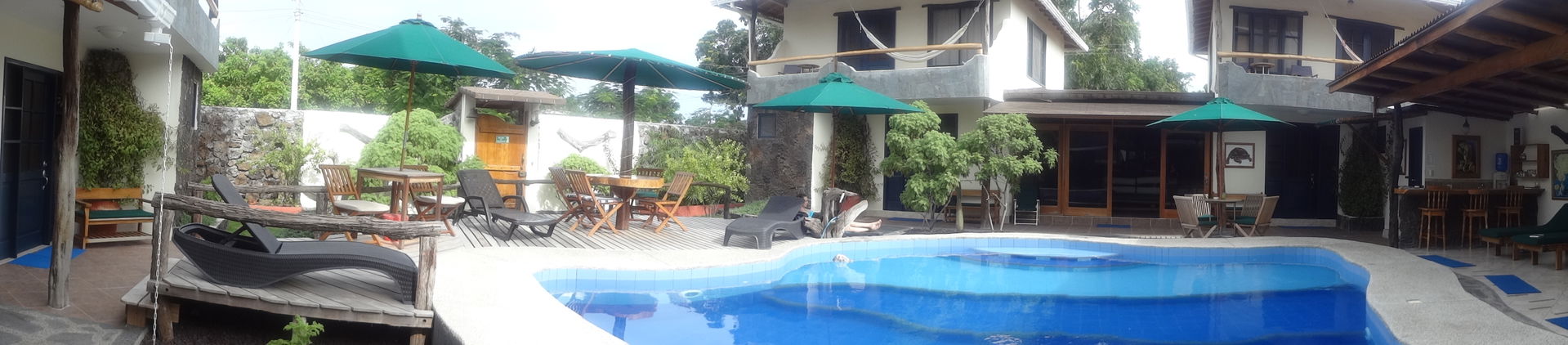 A panoramic photograph, looking at the Galapagos Cottages.  The…