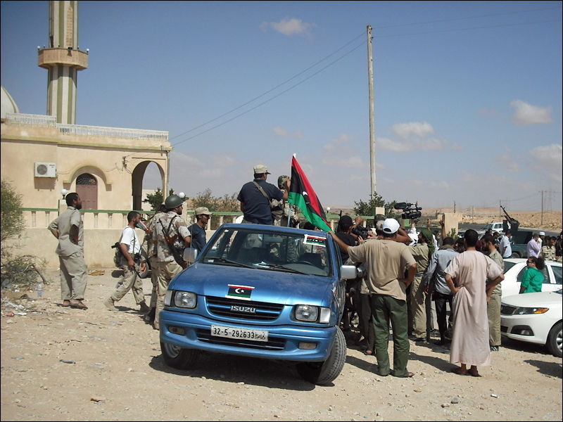[Essam Mohamed] Rebels and reporters gather outside the mosque …