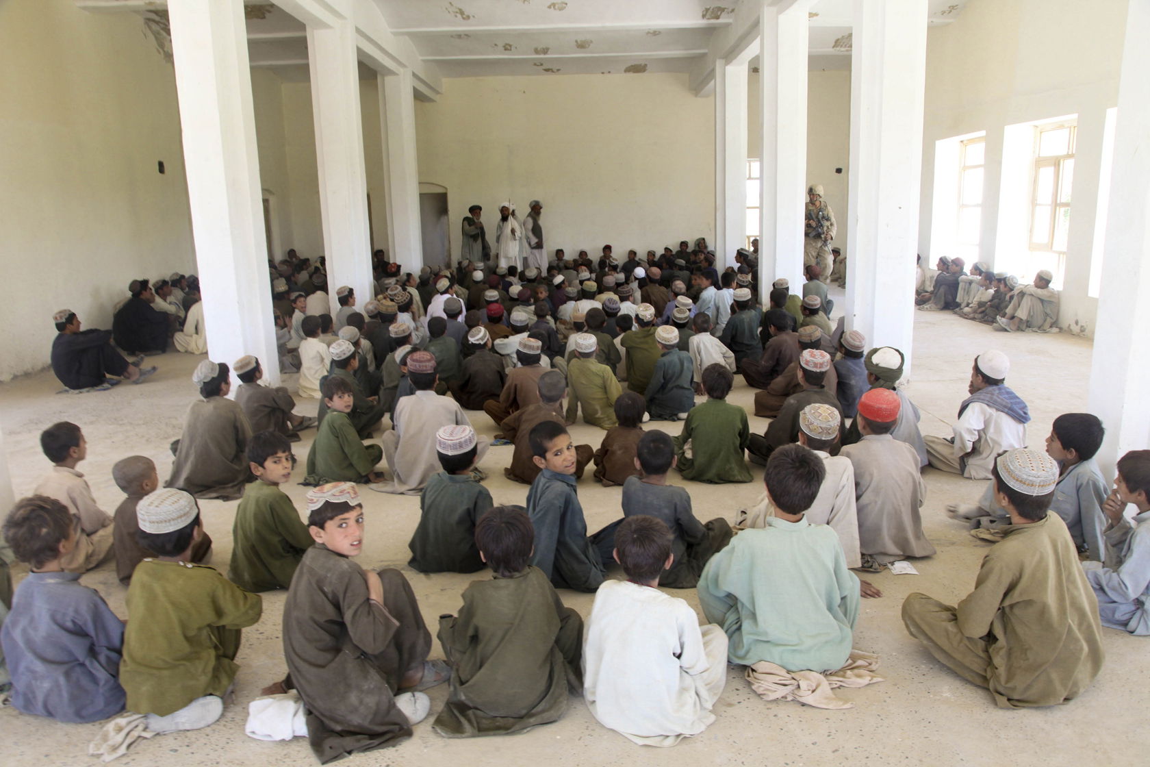 Afghan children wait on school supplies at the Nawa school hous…
