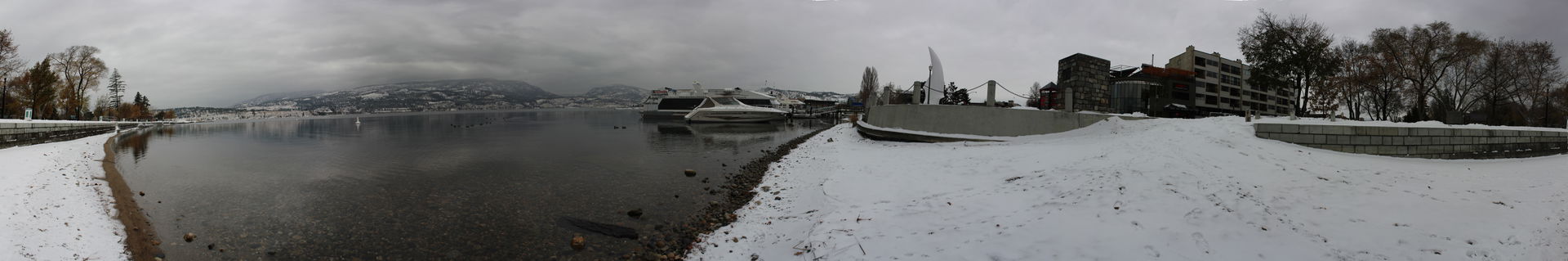 Kelowna City Park with snow covered mountains in the back groun…