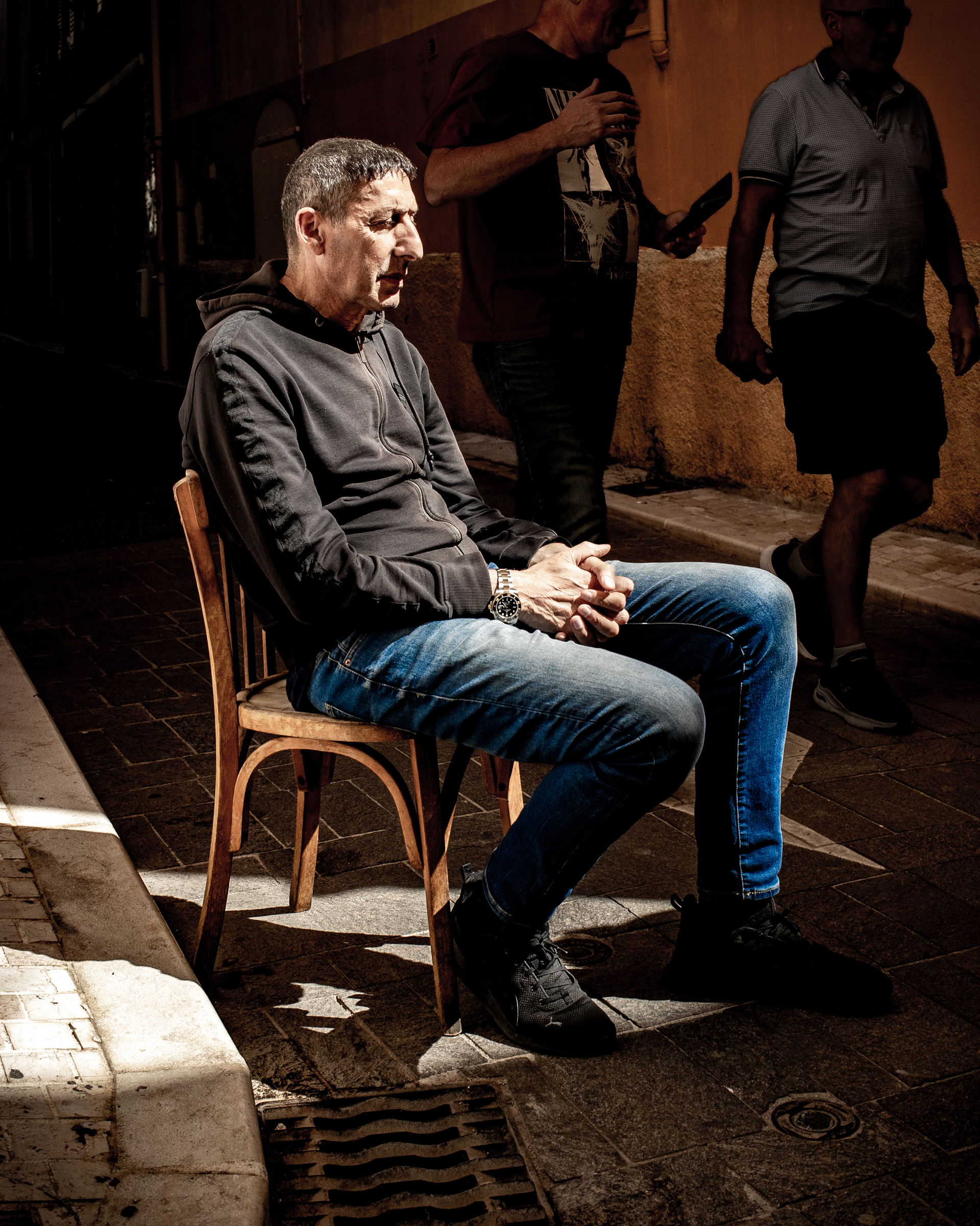 Man sitting on a chair, apparently lost in thought and daydream…