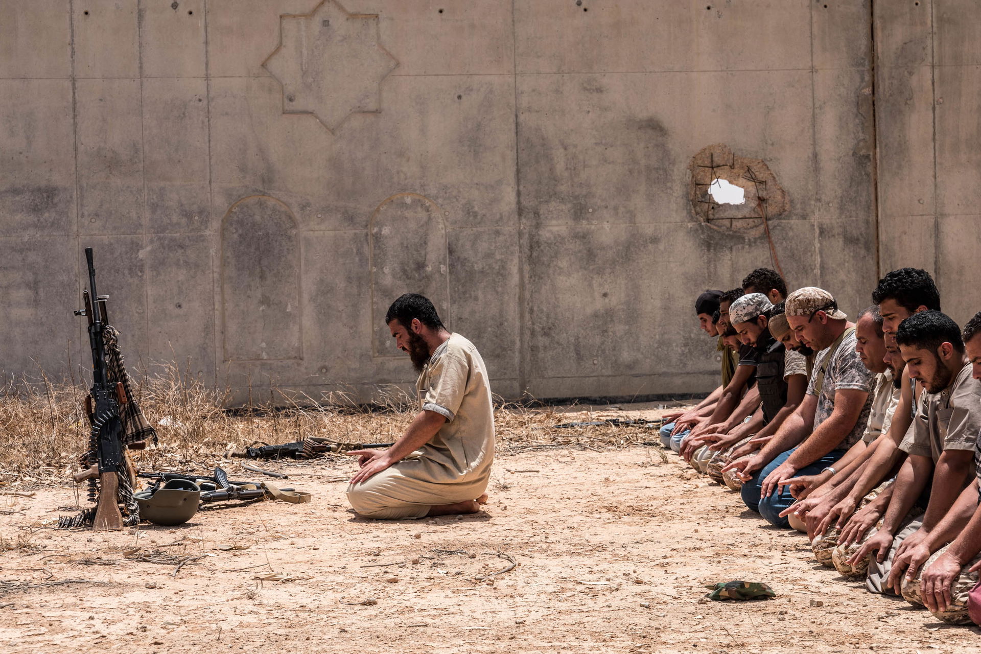 LIBYA.SIRTE.2.6.16. In front of Uagadougu center, soldiers pray…