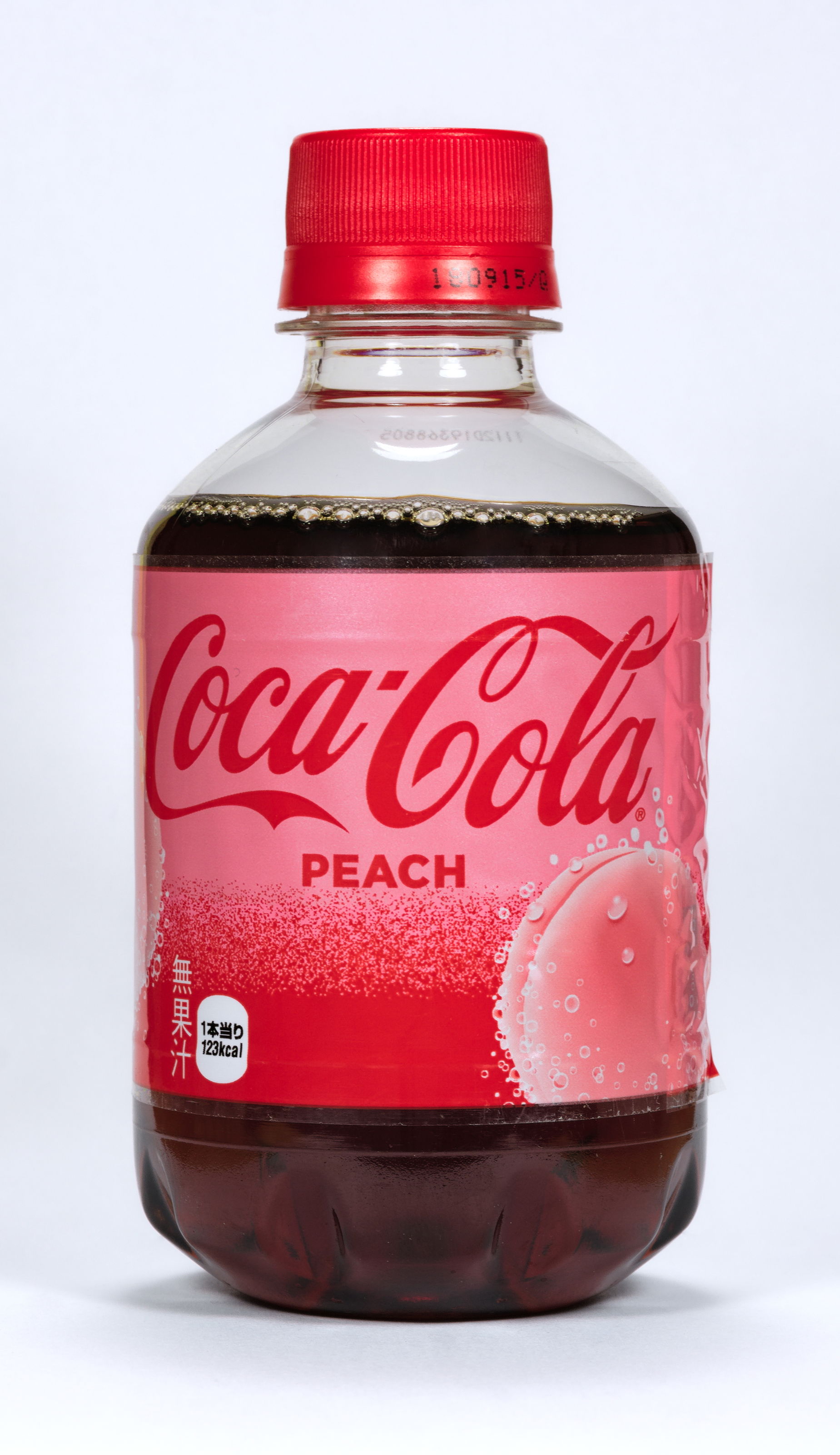 The front of a Coca-Cola peach bottle by The Coca-Cola Company