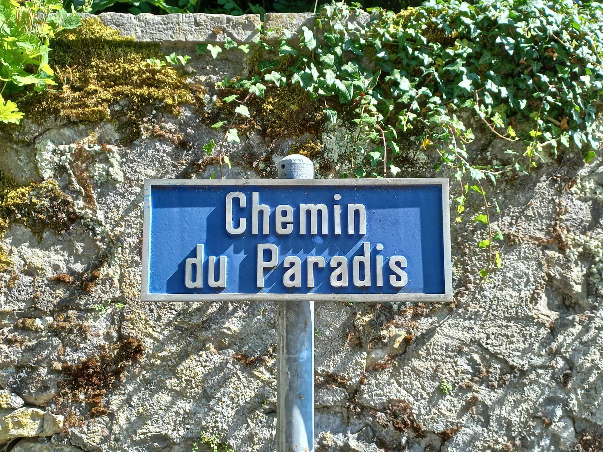 Street sign of the "Chemin du Paradis" ("Path to Paradise") in …