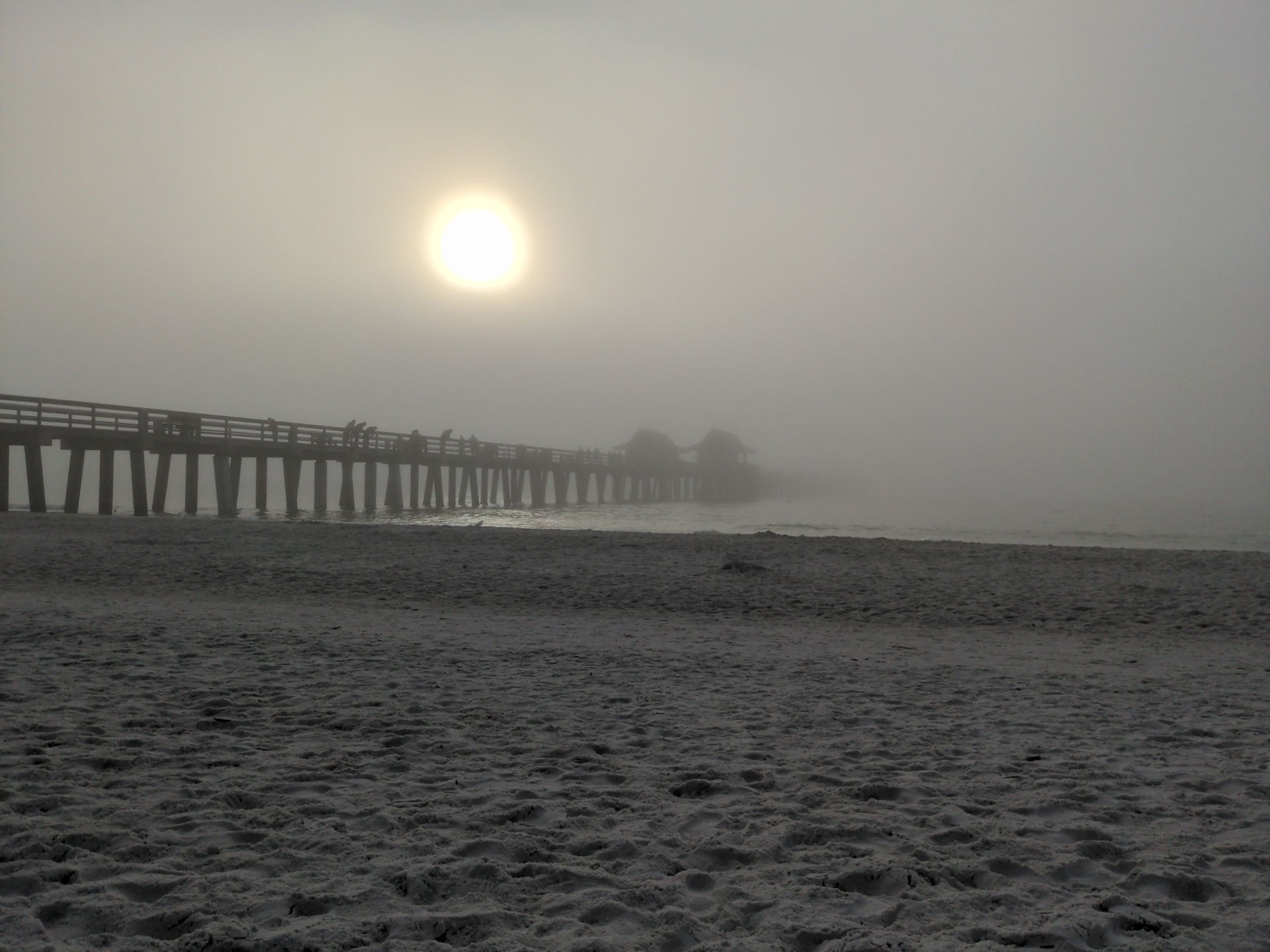 The pier of Naples in the fog