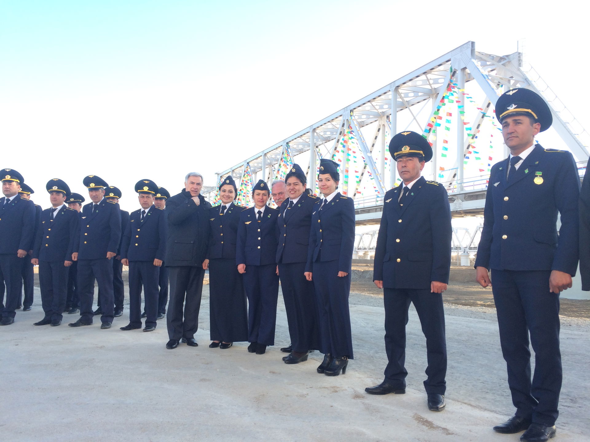 Photo of Turkmen Rail employees posing in front of the new rail…