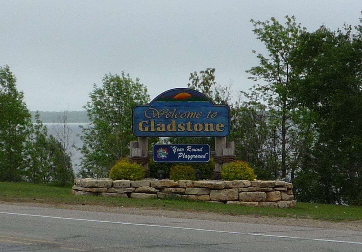 Welcome sign for Gladstone, Michigan, USA. Little Bay de Noc is…