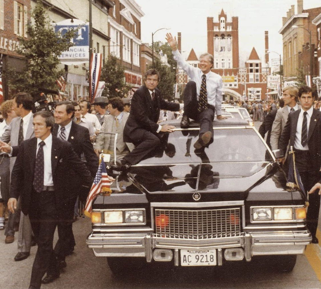 President Jimmy Carter, flanked by nervous Secret Service agent…
