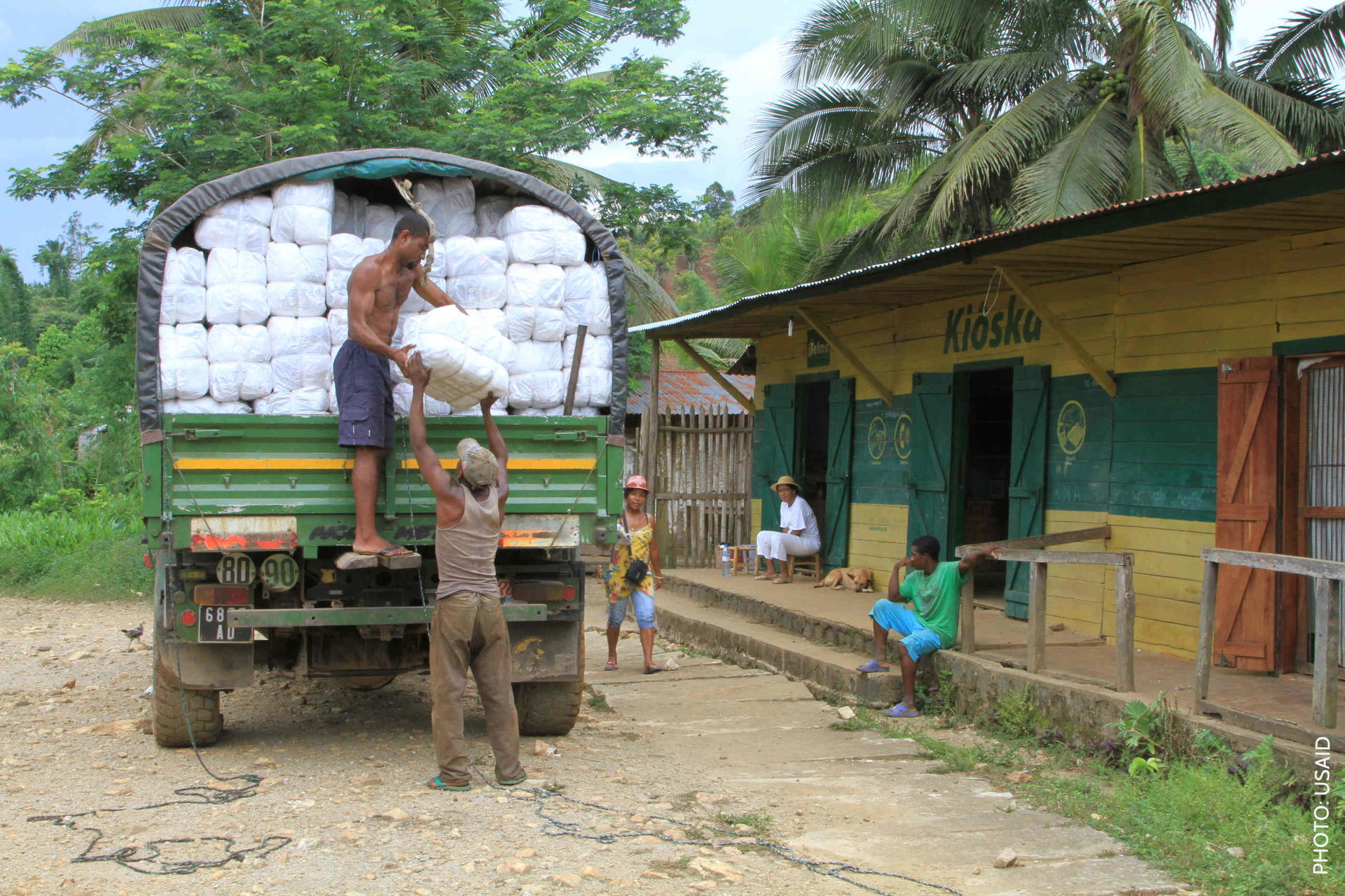 Photo: USAID Workers unload bales of bed nets in Vavatenina dur…