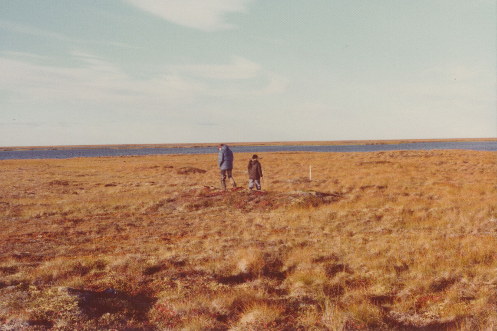 A couple of native kids walking over the tundra at Newtok, AK.