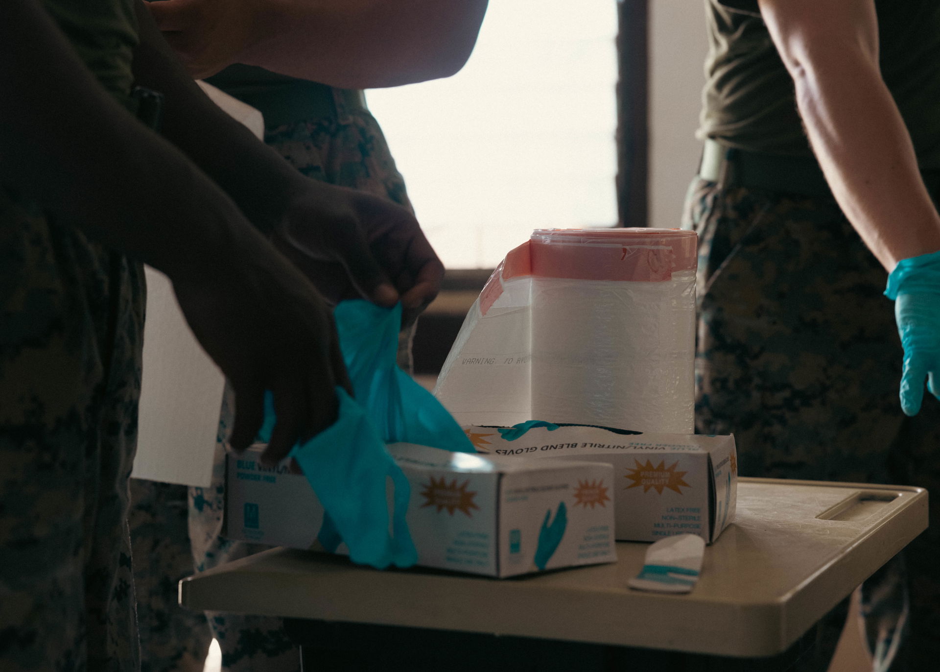 U.S. Marines stage trash bags and gloves in preparation for a c…