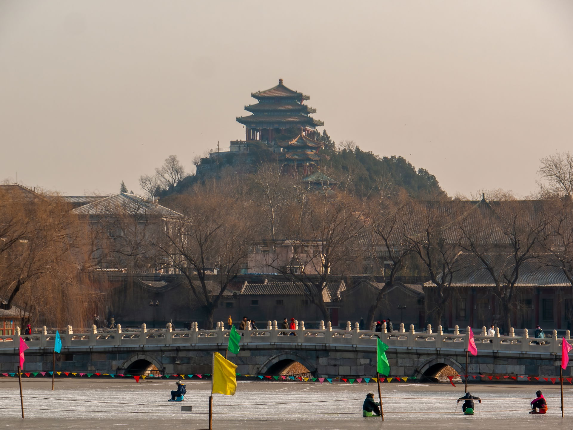 Bridge over the ice of the pond in Beihai Park