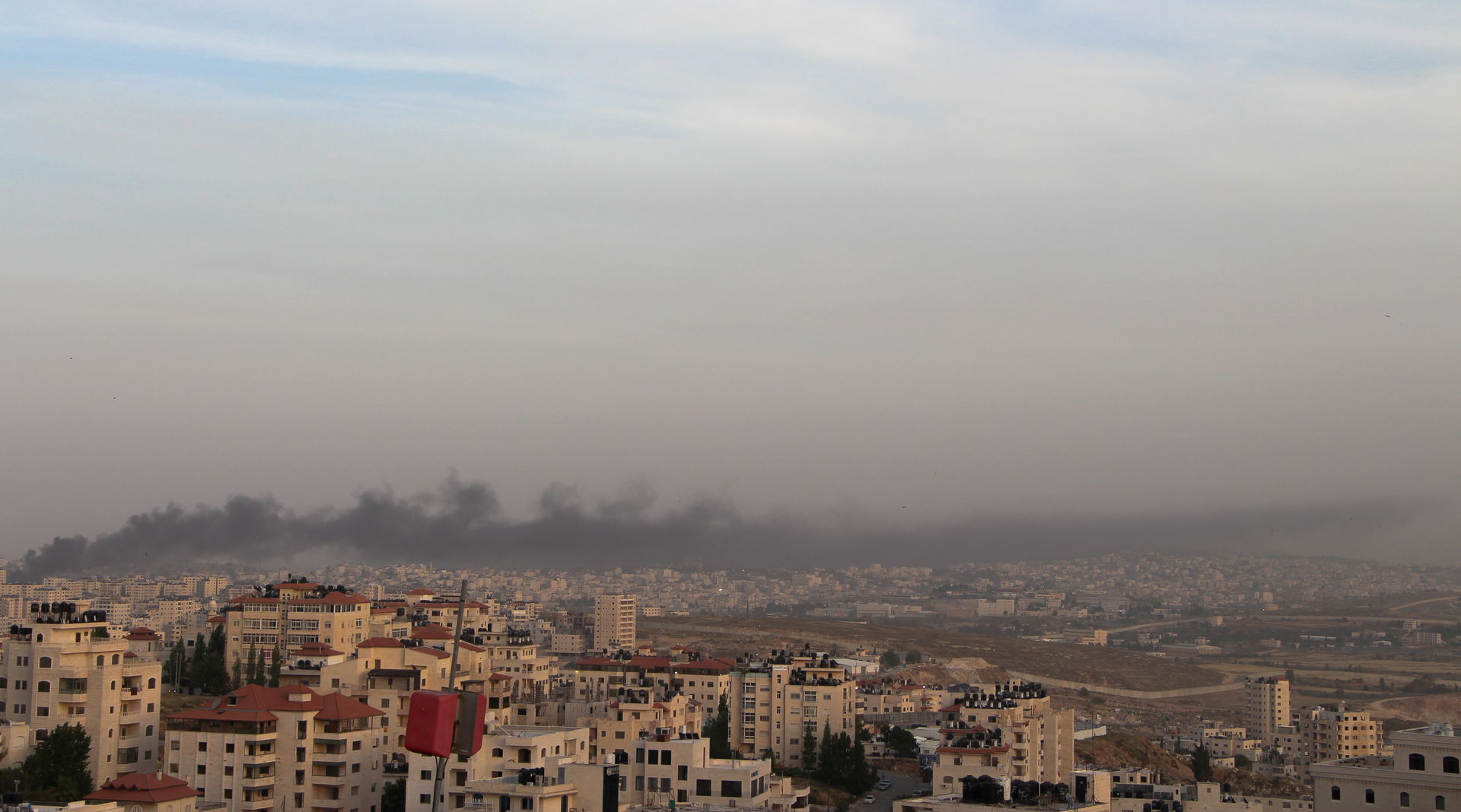 A photo taken of Ramallah, Palestine while waste was being burn…