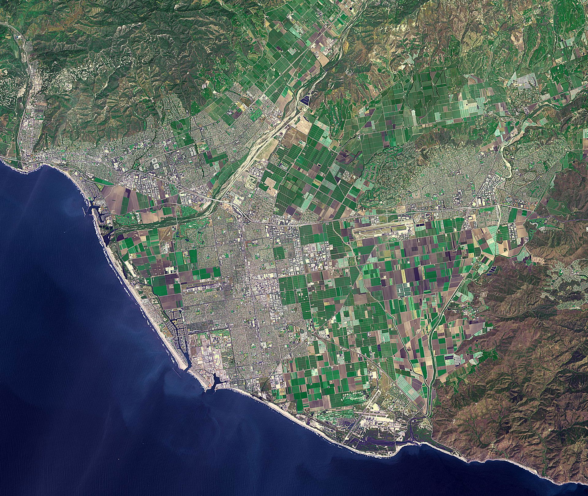 Ventura, California has a coastal site, set against hills and f…
