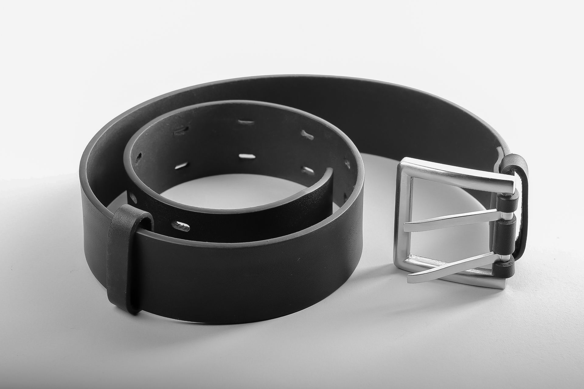Black leather belt with a silver-tone buckle