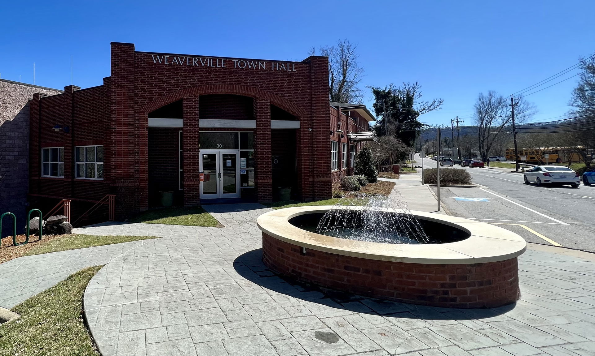 Weaverville Town Hall, a stout, modern building made of red bri…