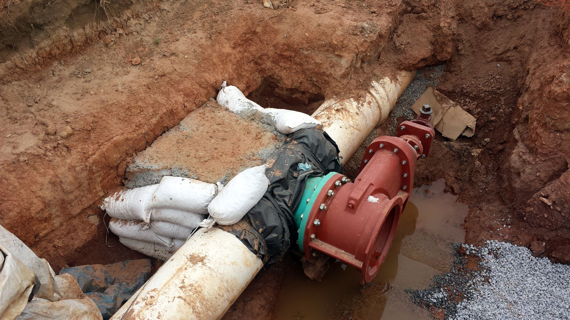 A tapped 18" water line with an 18" gate valve and concrete thr…
