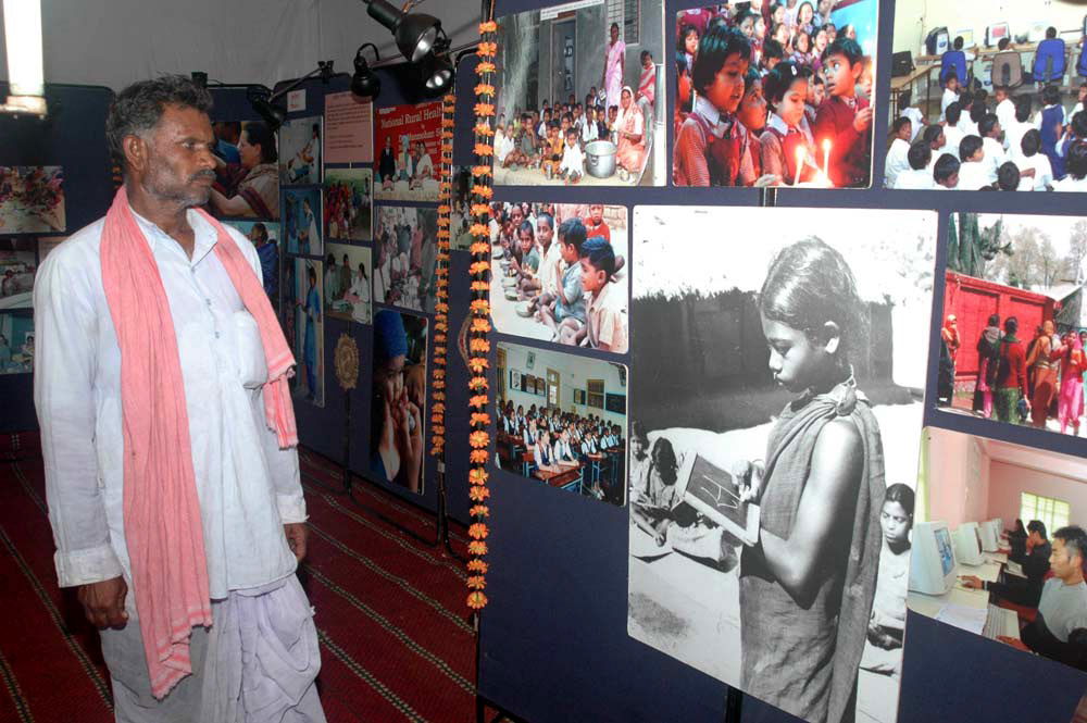 A farmer evincing interest in the Educational section of photog…