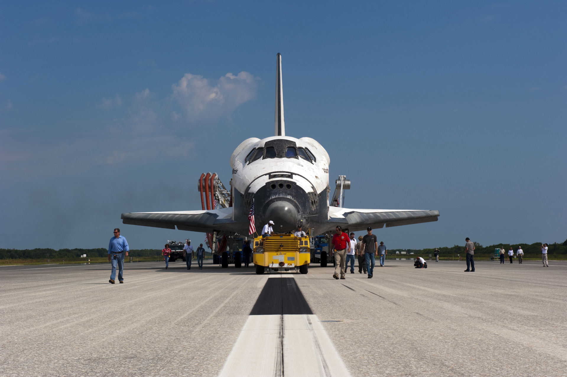 CAPE CANAVERAL, Fla. – Workers accompany space shuttle Atlantis…