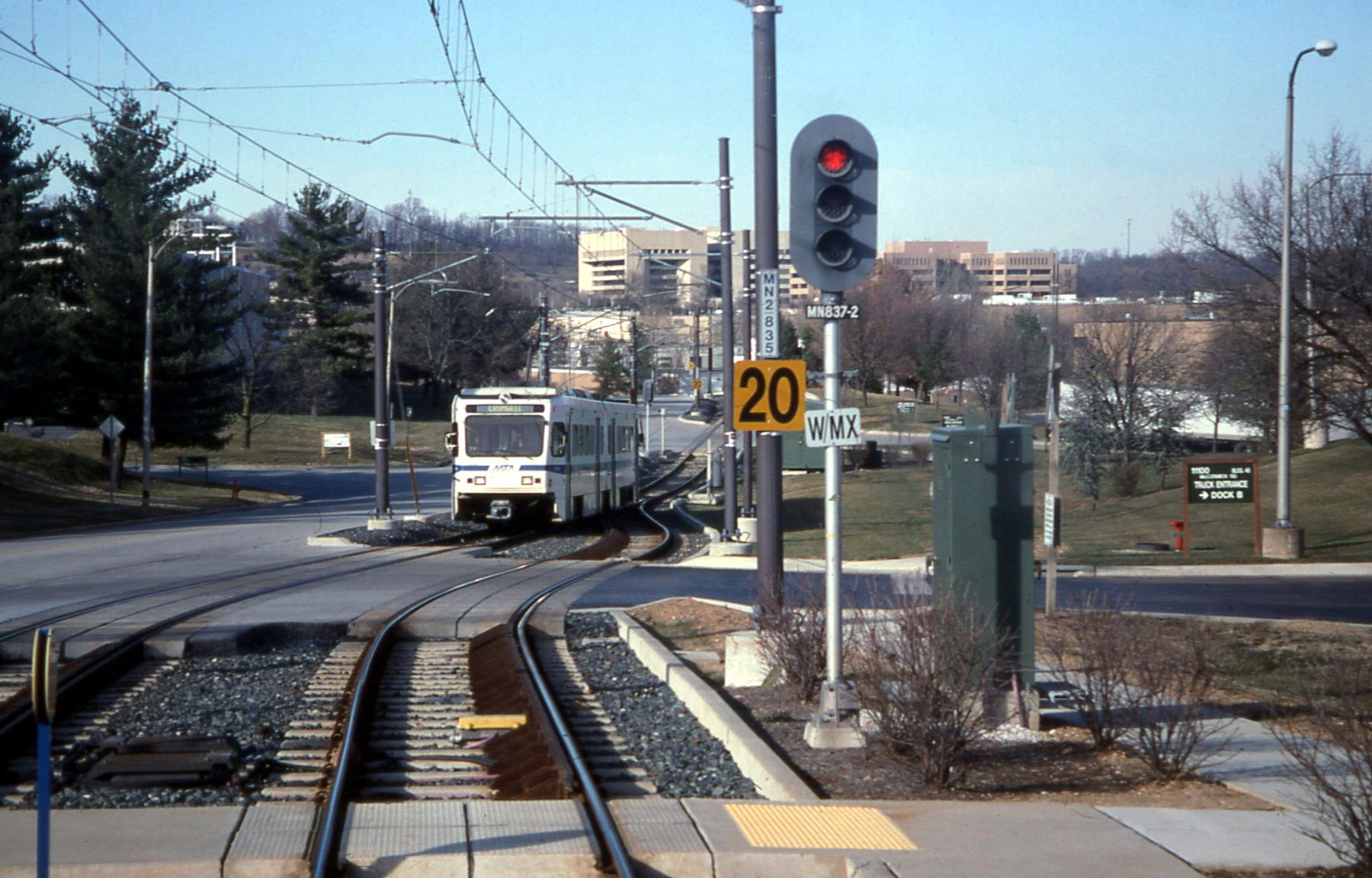 A southbound Baltimore Light Rail train enters Gilroy Road stat…