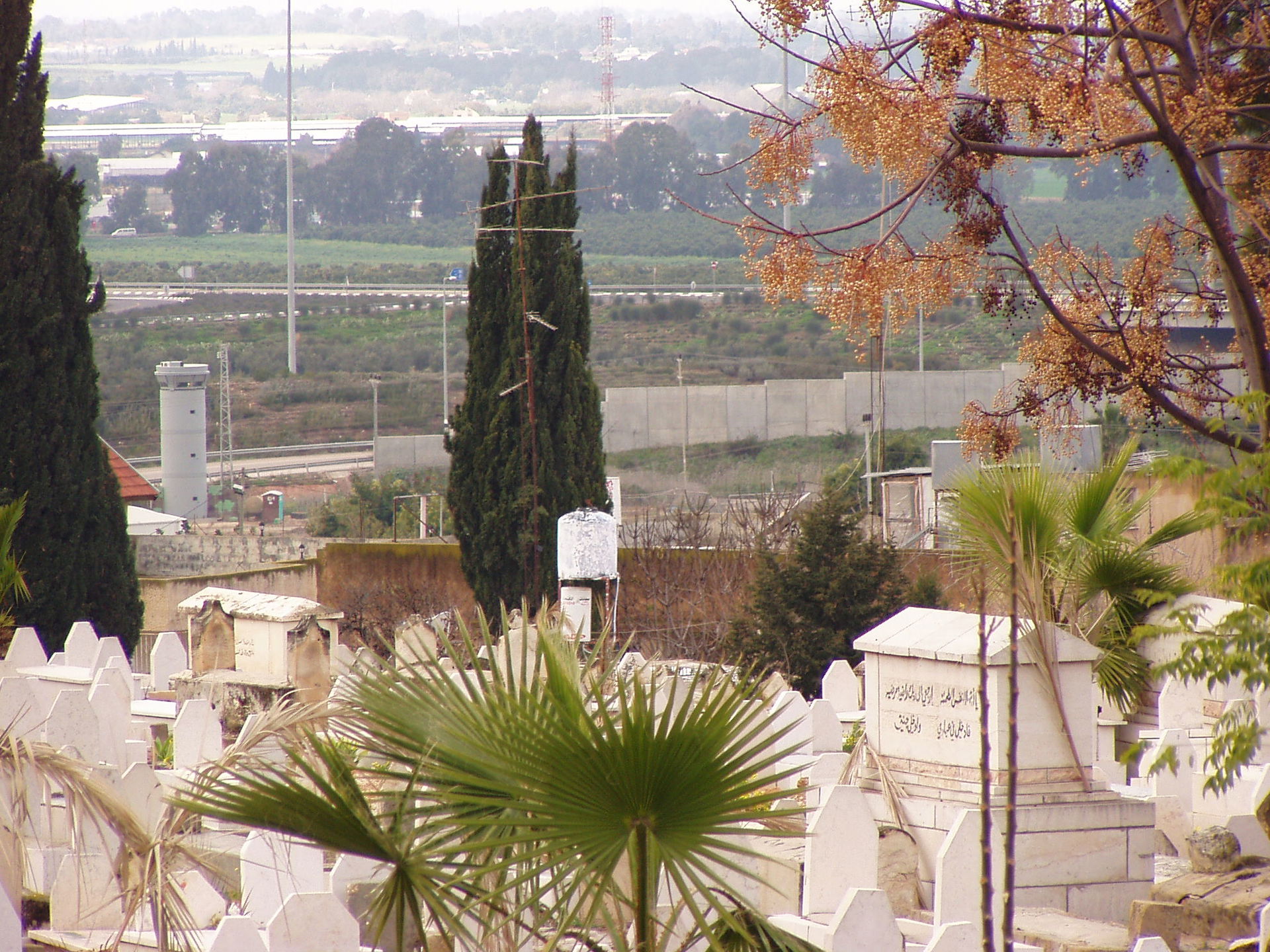 Tulkarm City cemetery with separation wall right behind. West B…