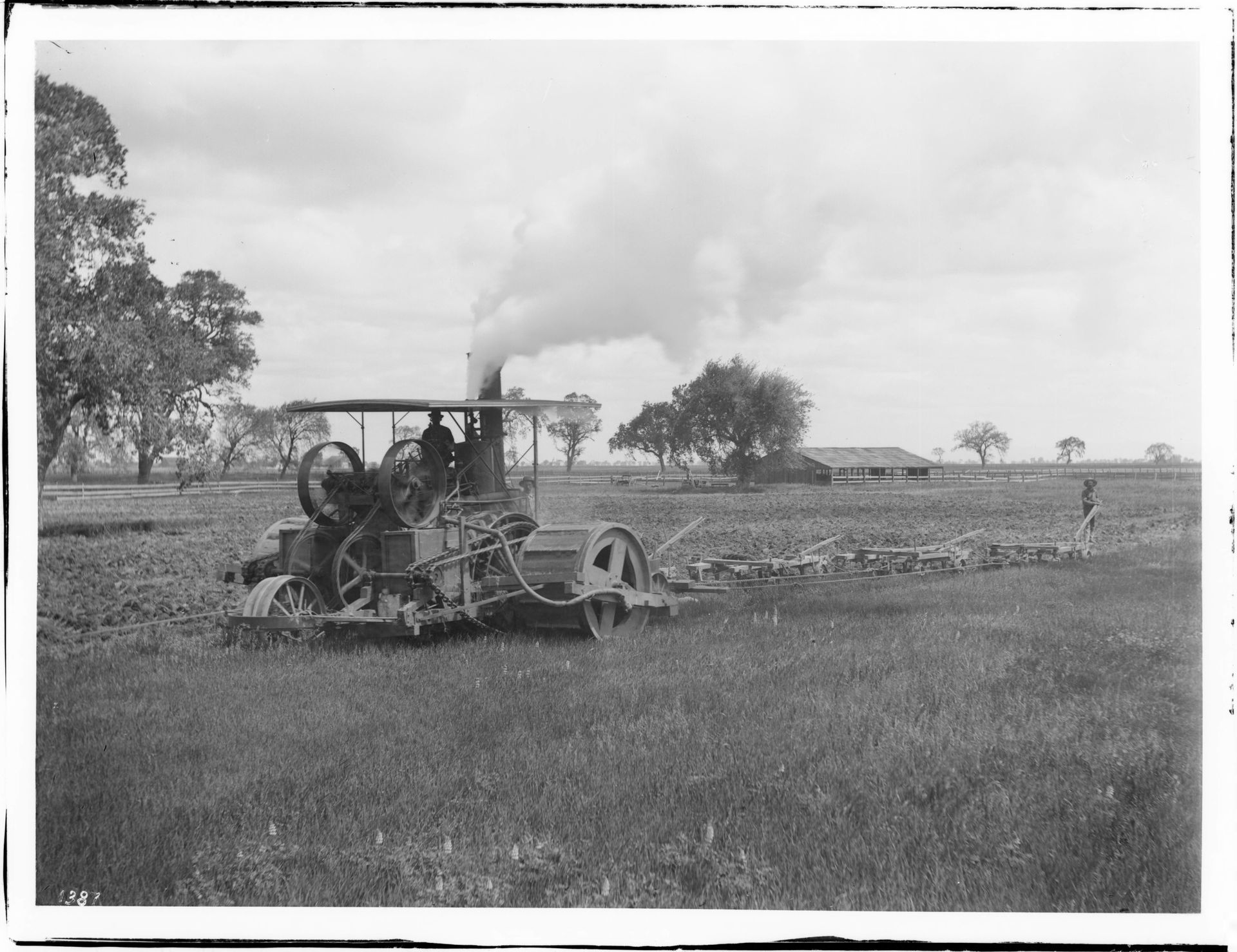 Two men operating a steam plow in a field near Hanford, Kings C…