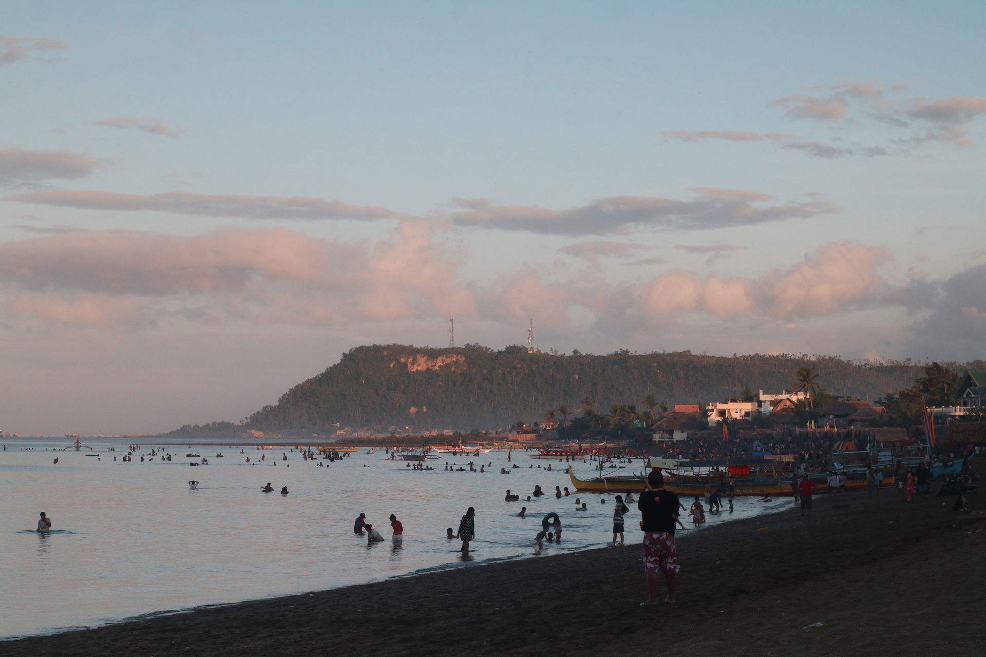 Taken during dusk, the image is of a beach in Pasacao during th…