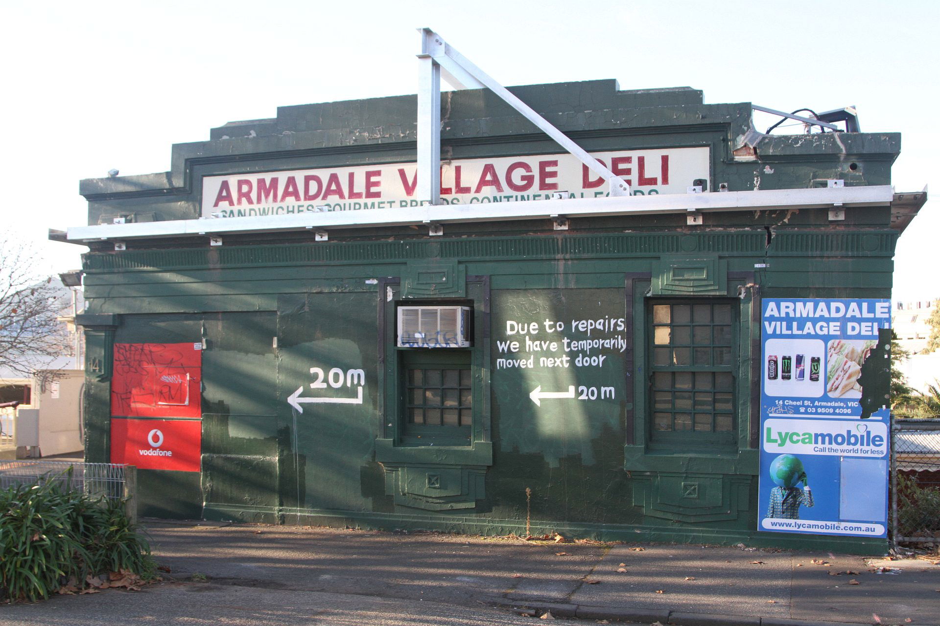 Steel frame retains the crumbing parapet of the kiosk above Arm…