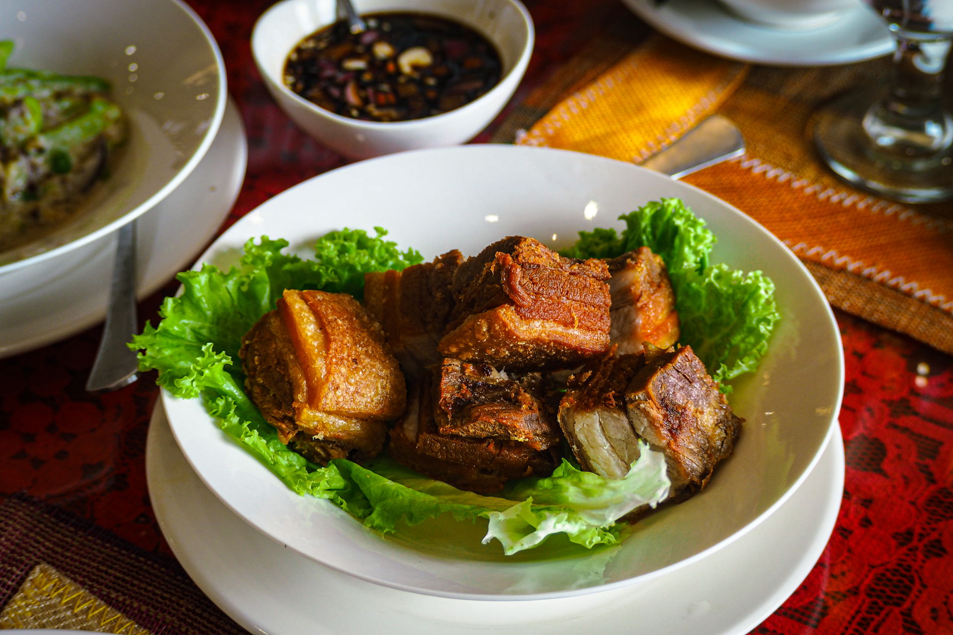 The photo highlights a plate of Lechong Kawali, a mouthwatering…