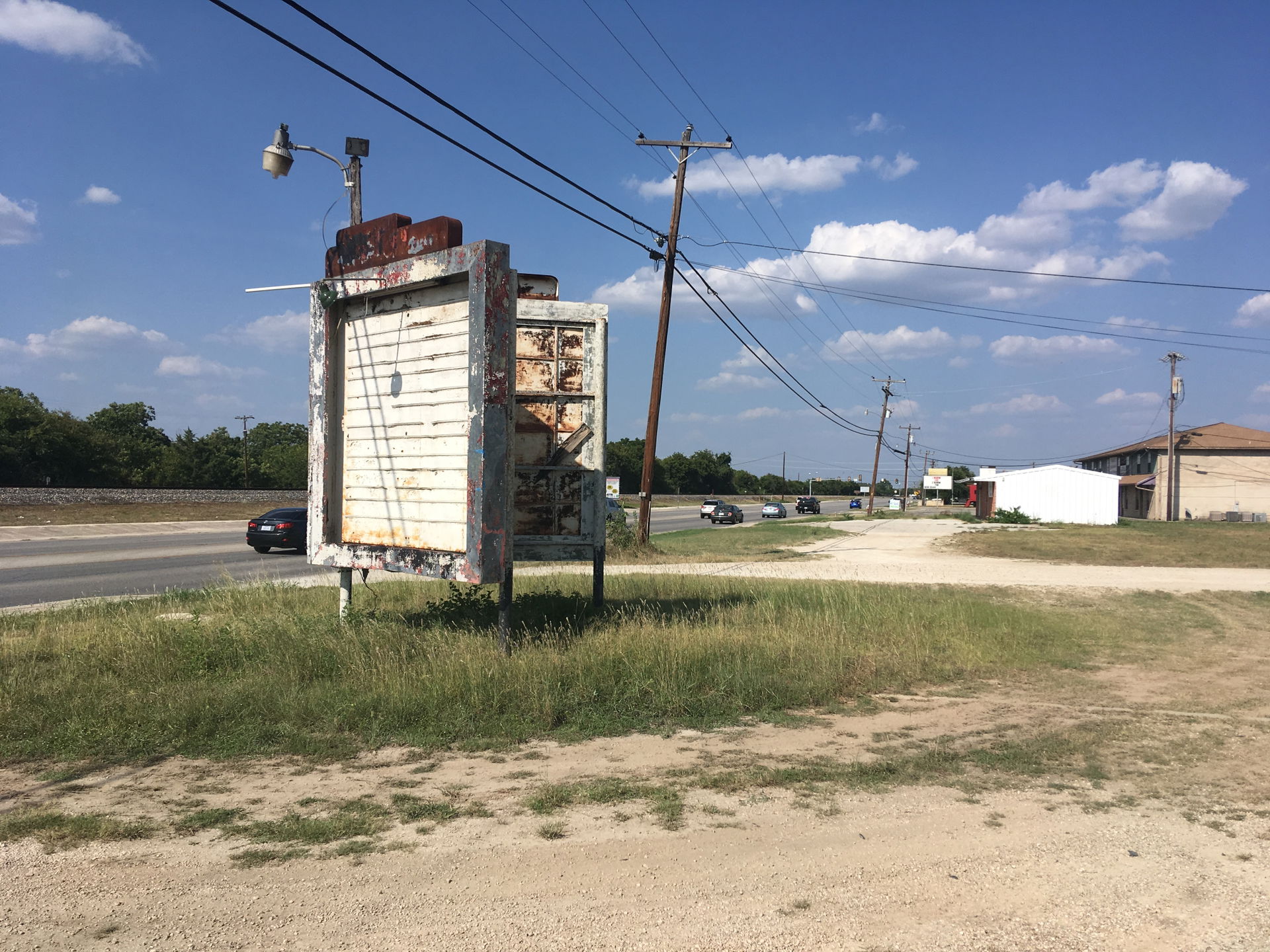 A decrepit car lot in Schertz Texas with interesting vintage si…