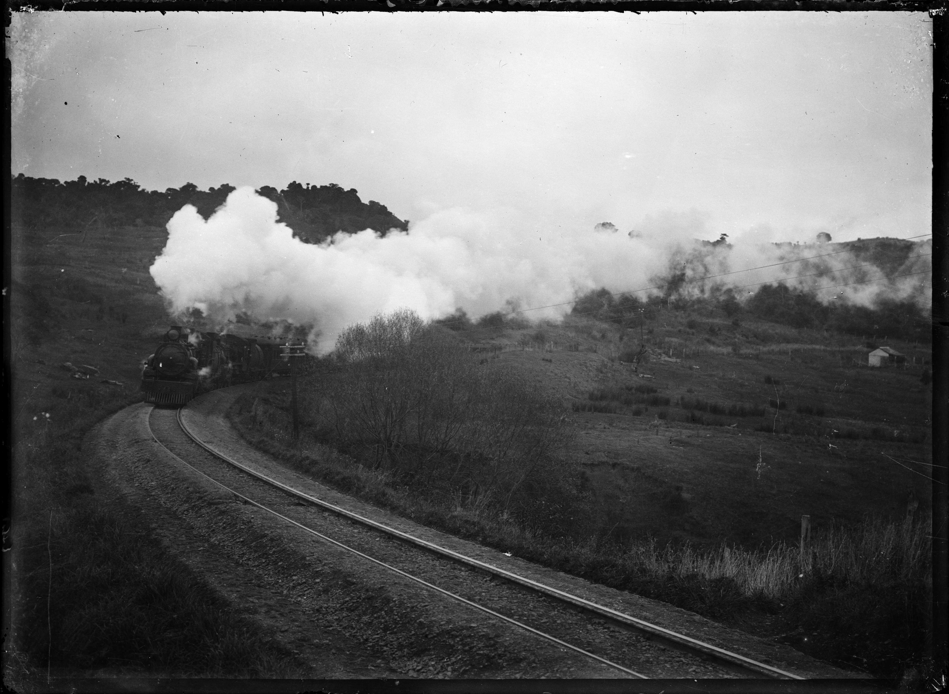 A train with two "Ab" class locomotives coming up a hill. Phot…
