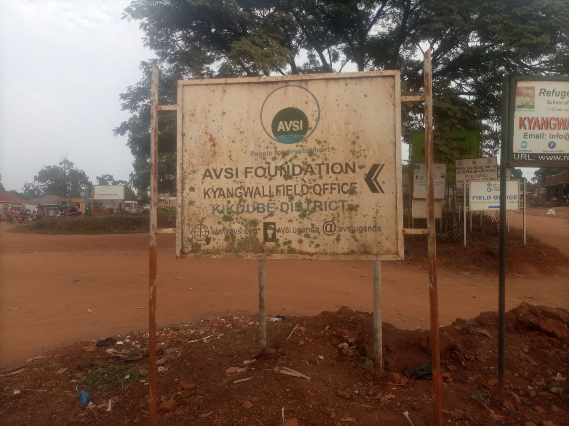 Directional signpost to AVSI FOUNDATION, Kyangwali field office…