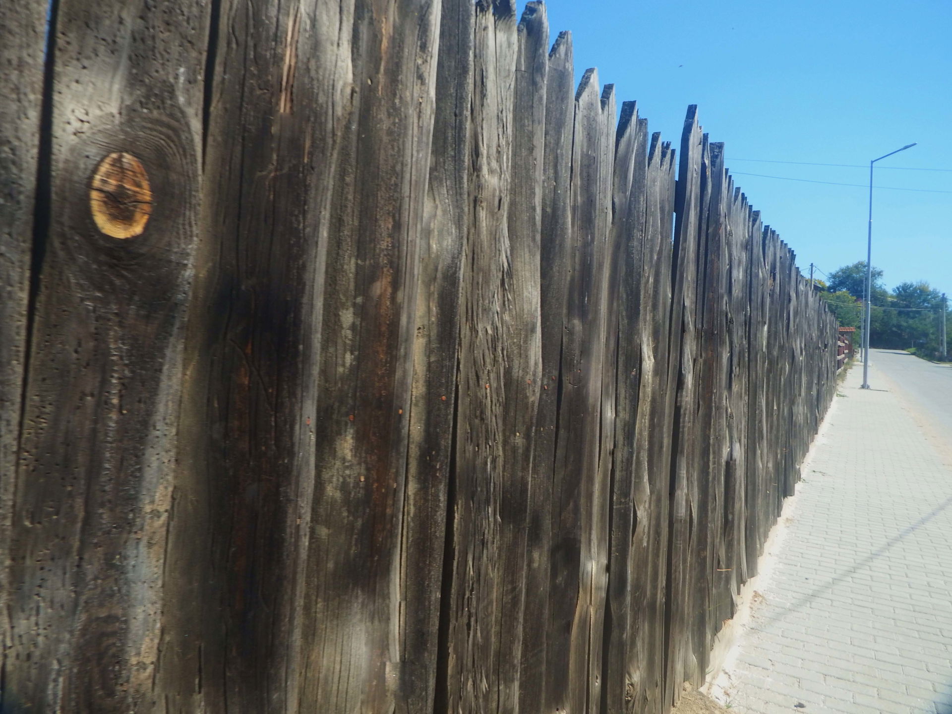 Wooden fence of the four-star hotel named "Monastery", because …