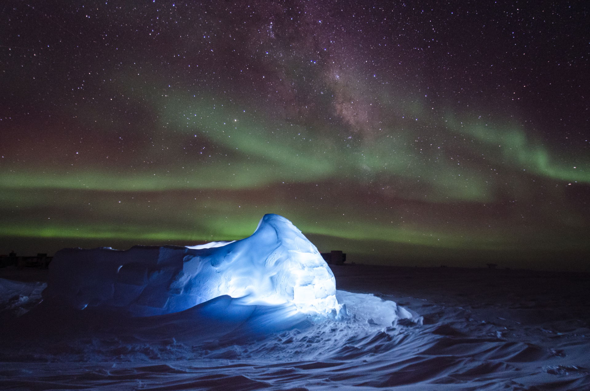 Aurora australis dancing over an LED illuminated igloo giving a…