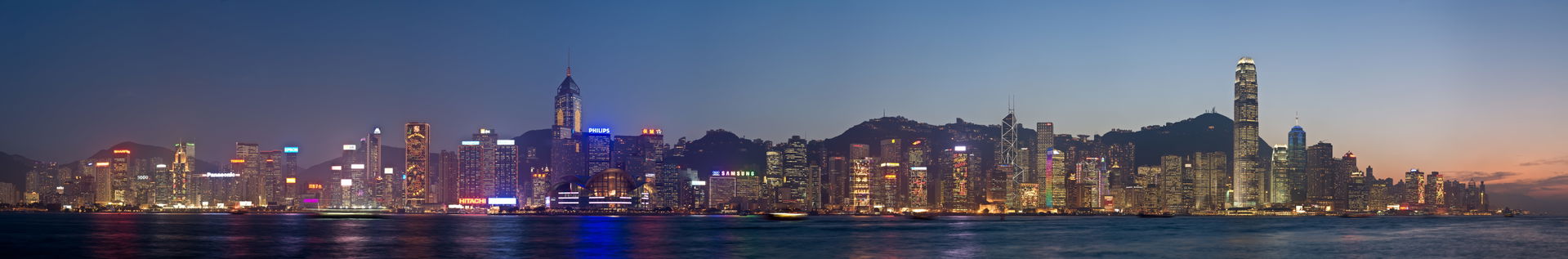 A 12 segment panoramic image of the Hong Kong skyline at dusk, …