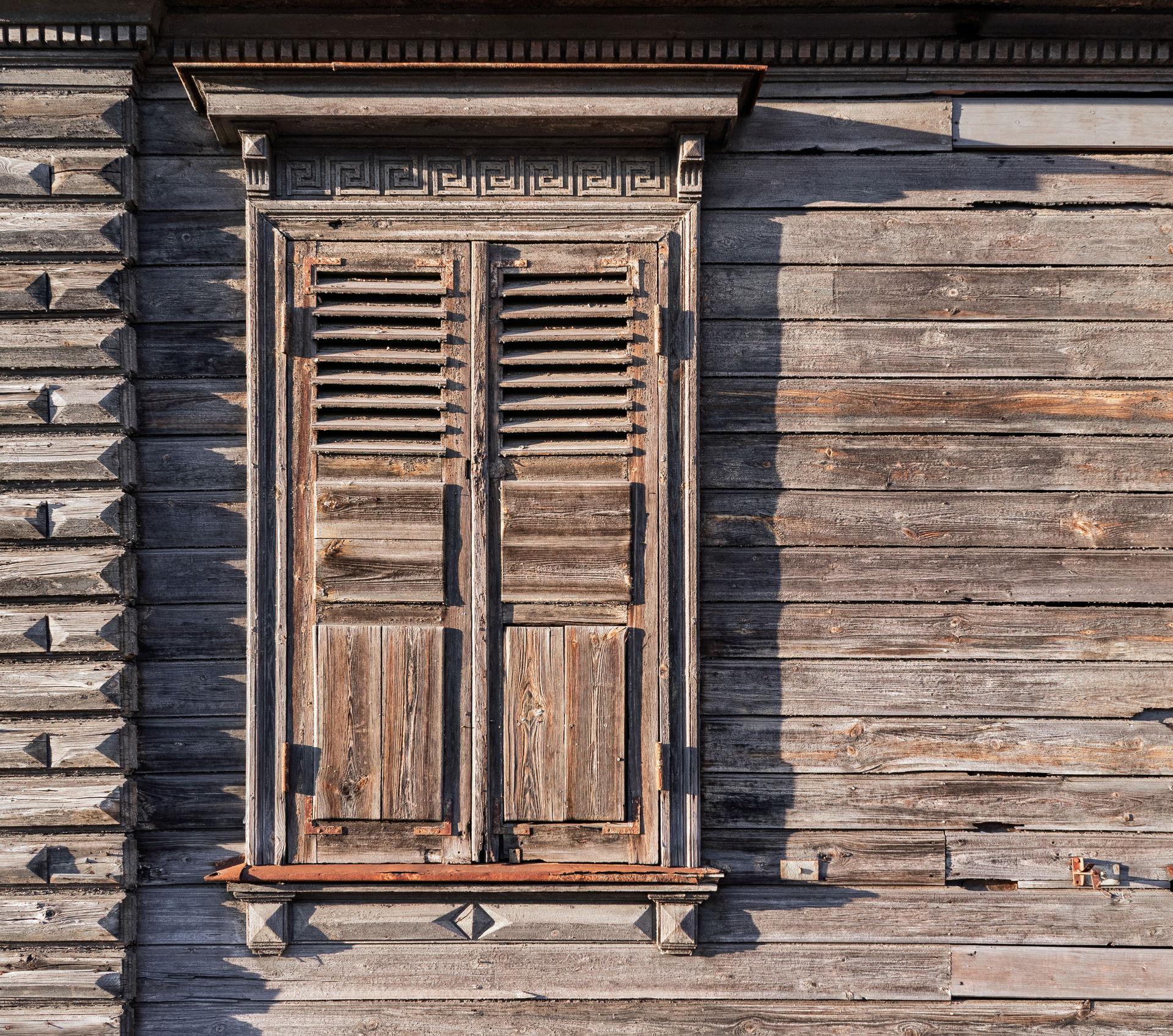 Close-up of weathered shutters on a historic wooden house at 1 …