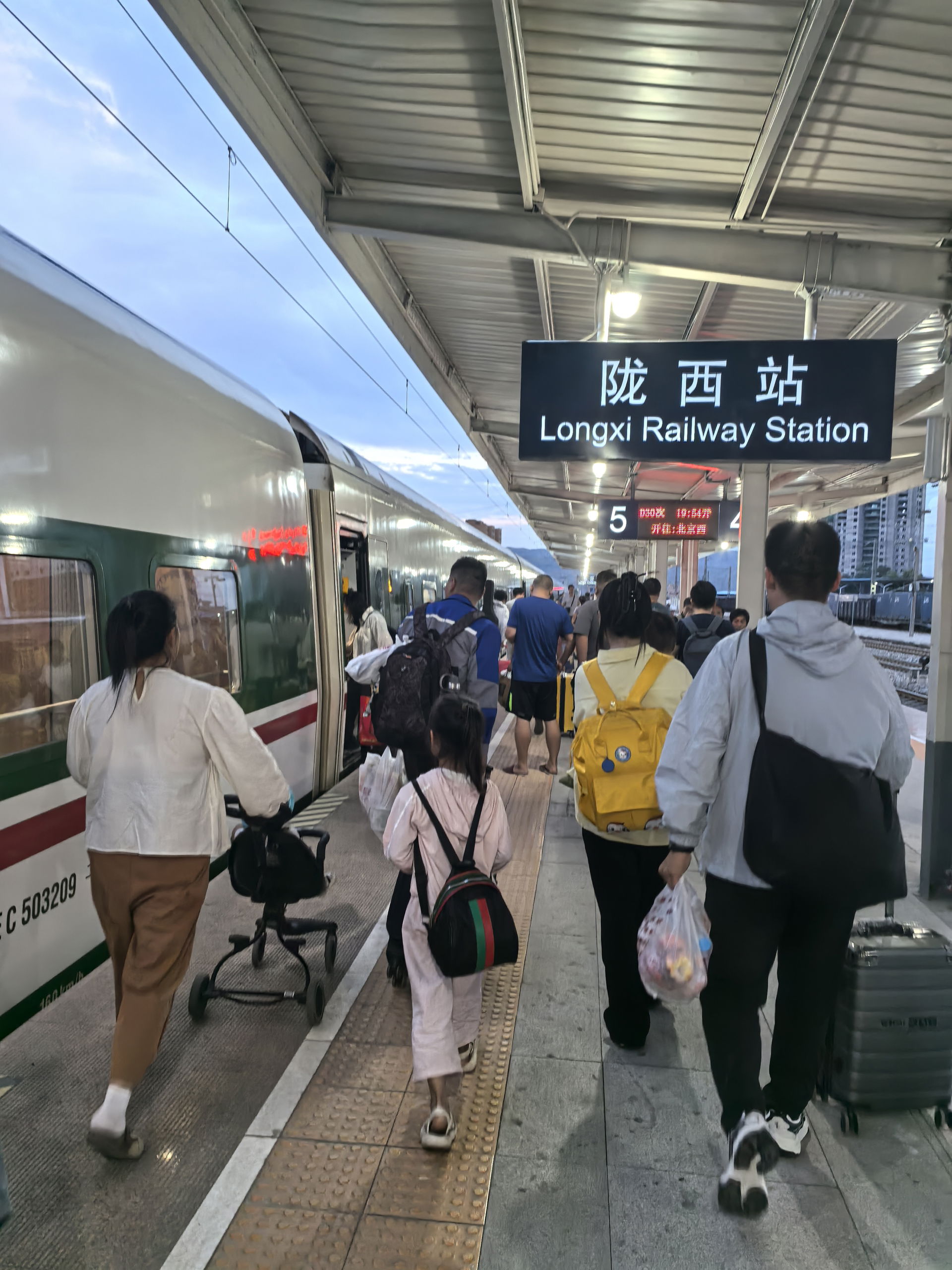 Passengers boarding a train at Longxi Railway Station