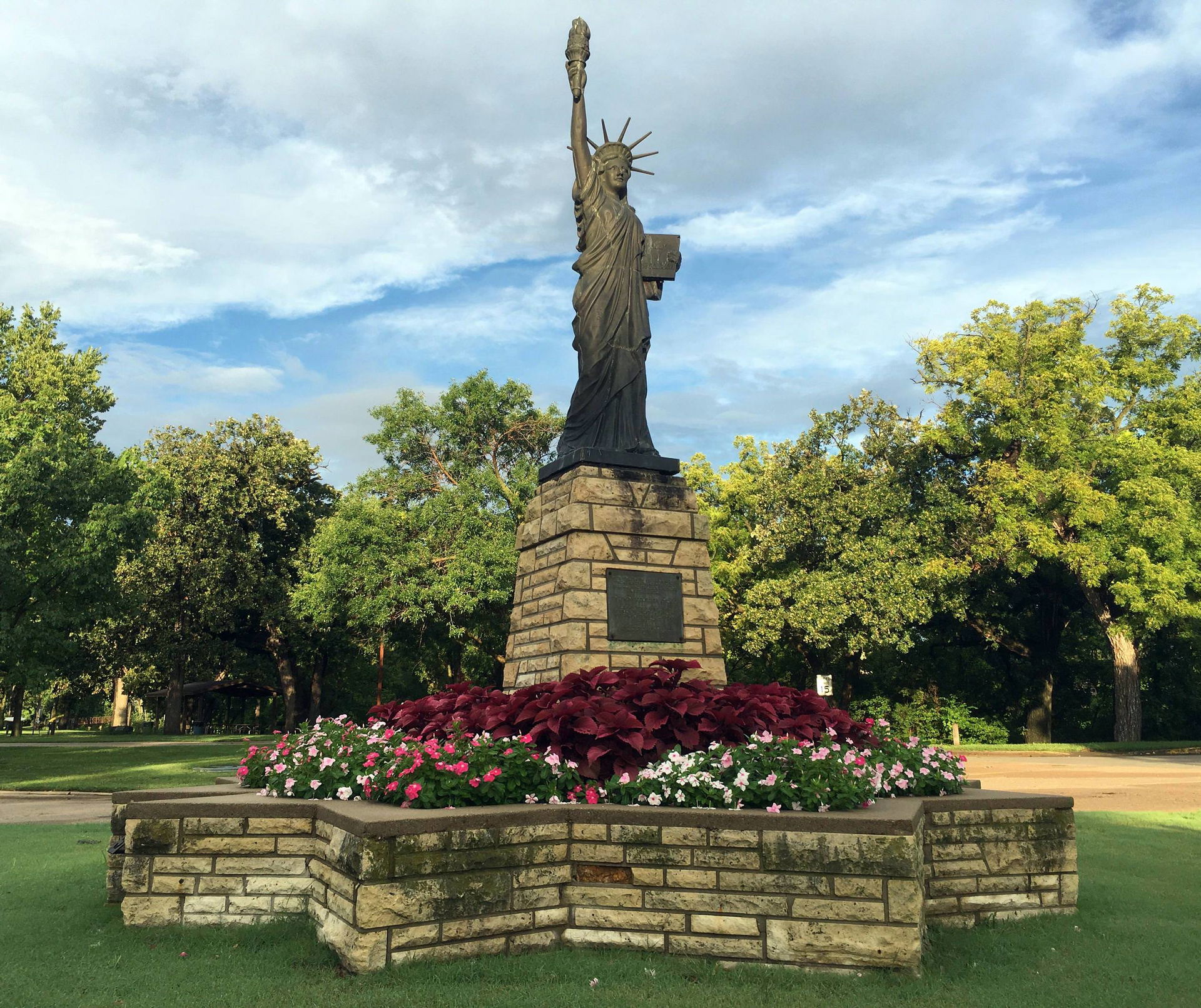 This is a scale model replica of the Statue of Liberty with ped…