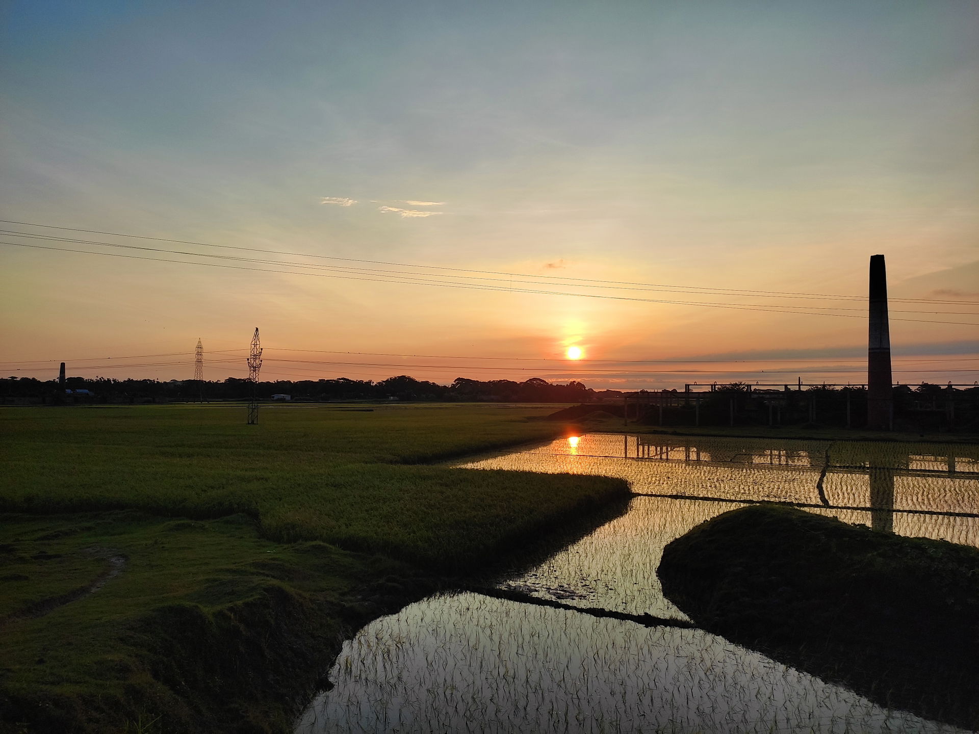 This photo represents a landscape of Kishoreganj when the sun w…