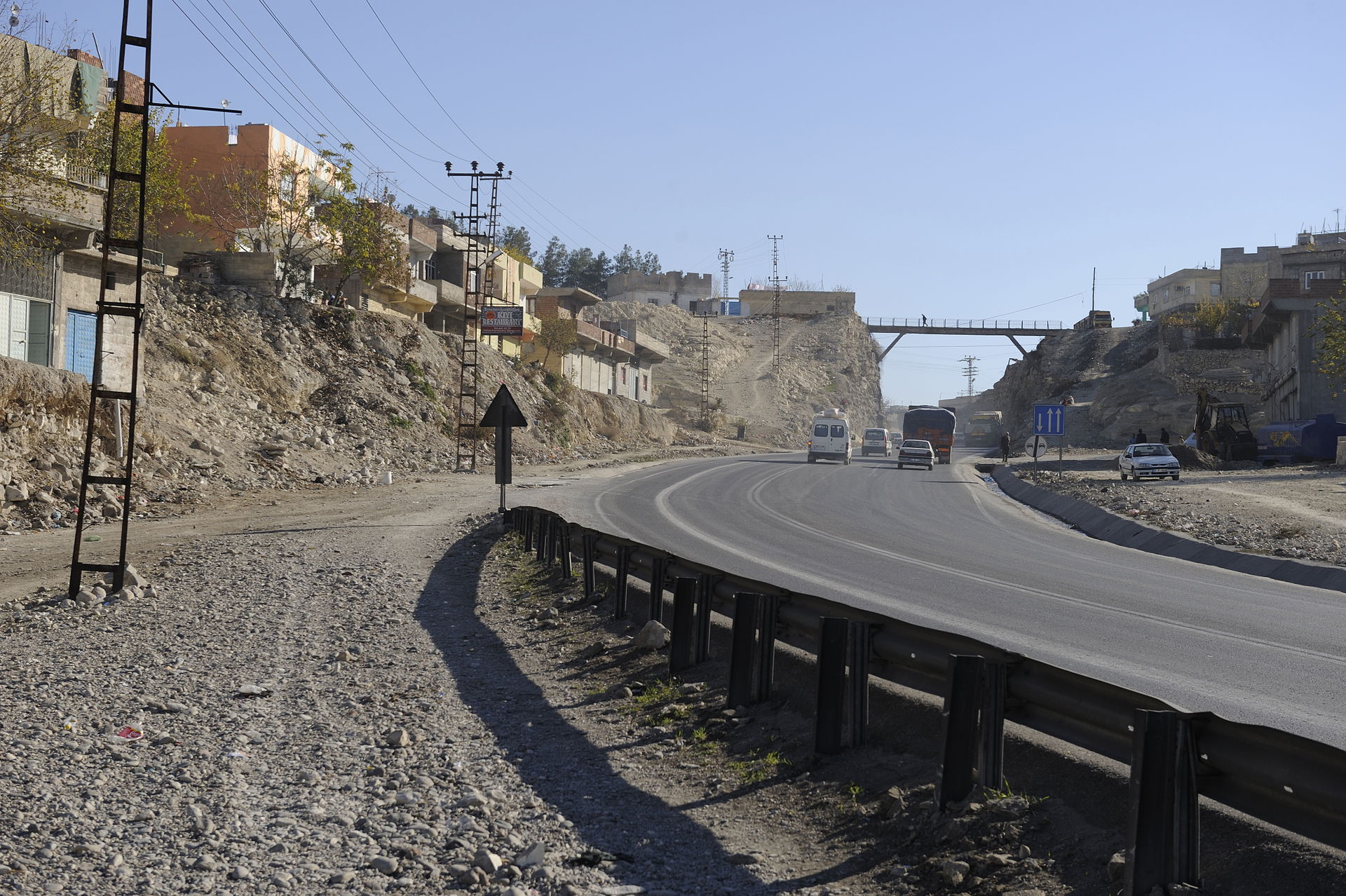 A road goes uphill and then through a tunnel, leading on to the…