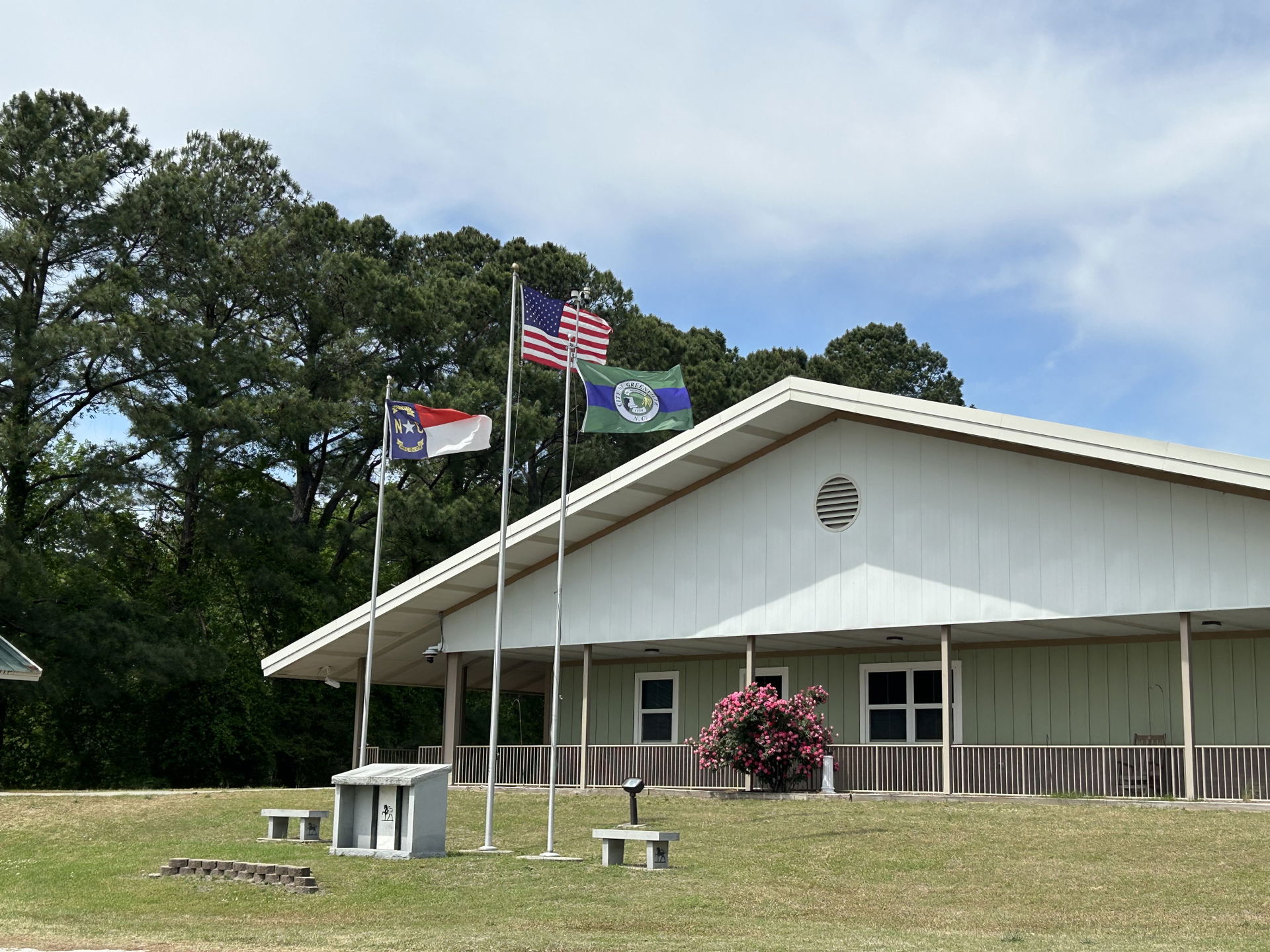 The national flag of the USA, the state flag of NC, and the cit…