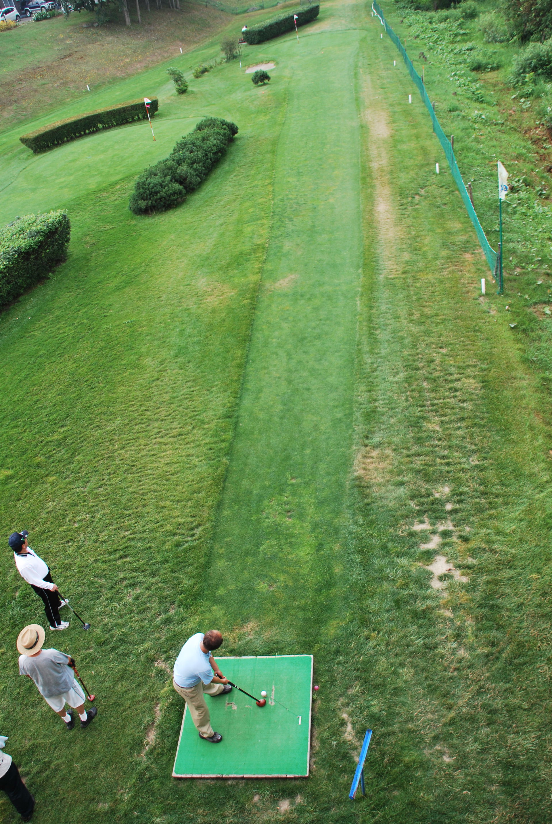 A man about to putt in a game of park golf on the Izarigawa Par…