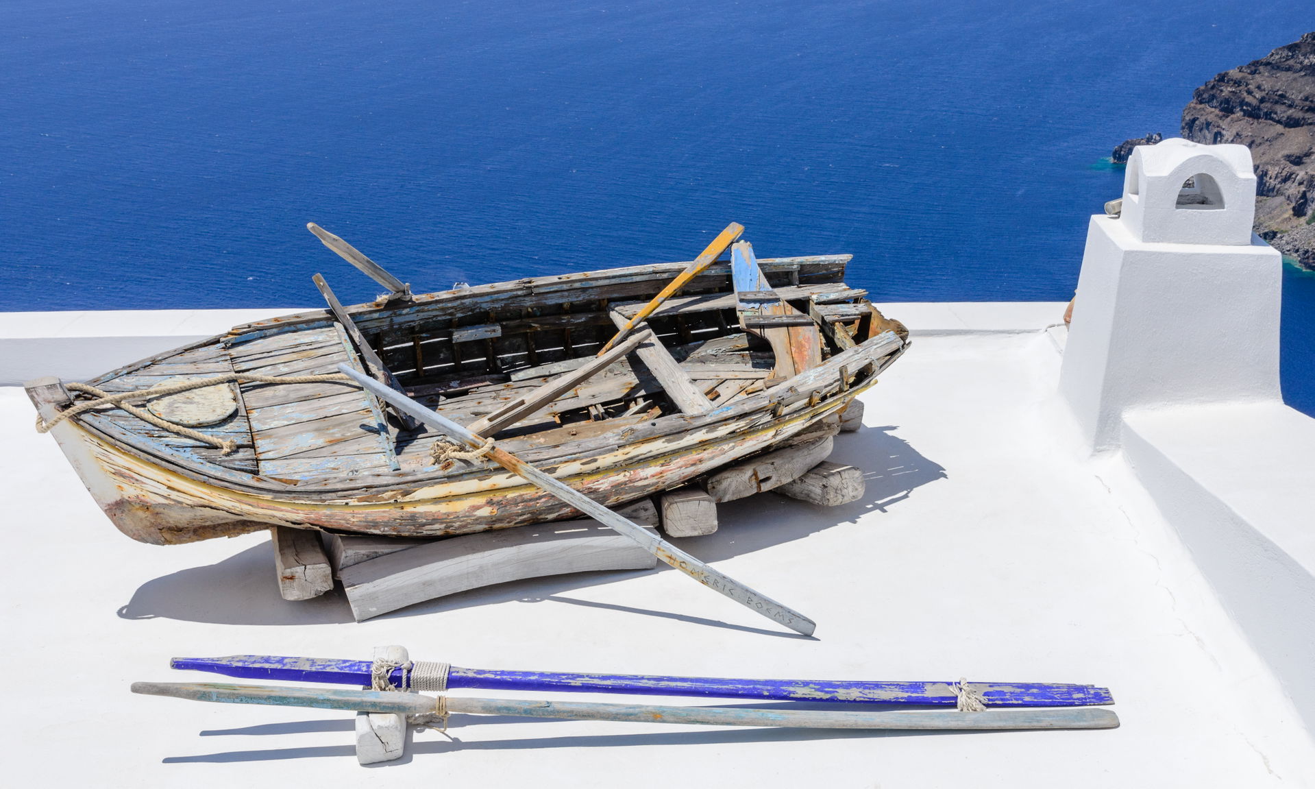 Rowing boat on a house roof, Fira, Santorini, Greece.